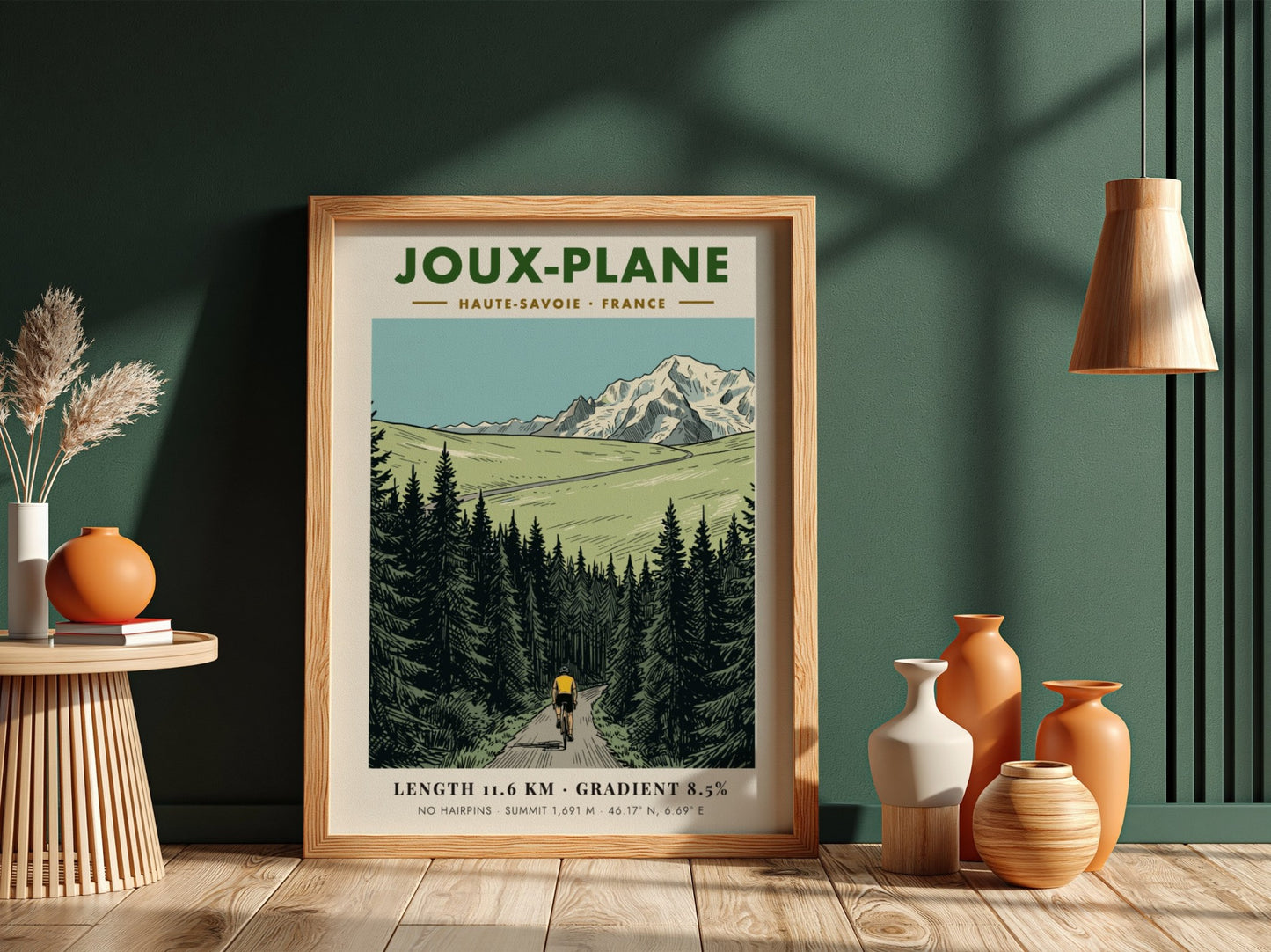 Poster of a cyclist climbing the winding road toward the snowy Joux-Plane mountain.