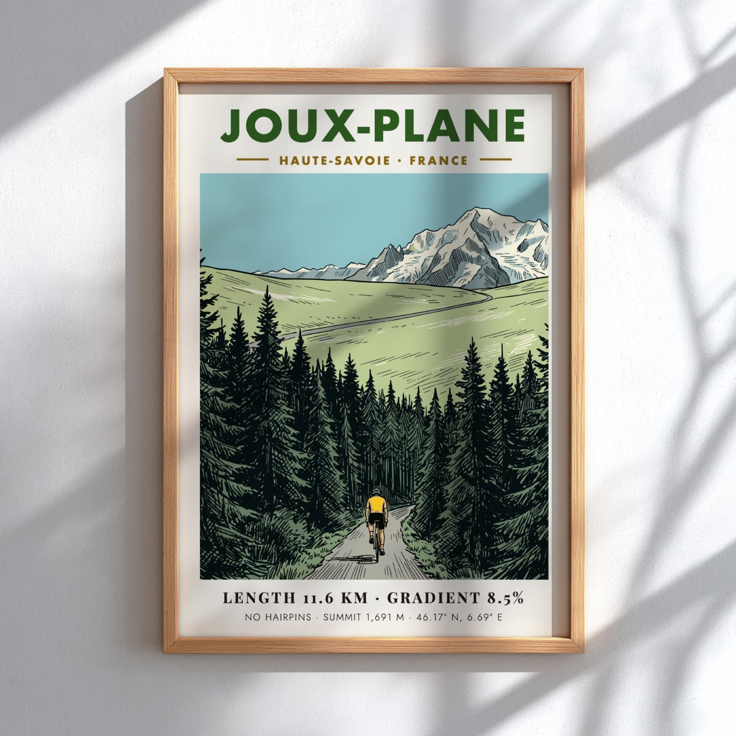 Poster of a cyclist climbing the winding road toward the snowy Joux-Plane mountain.