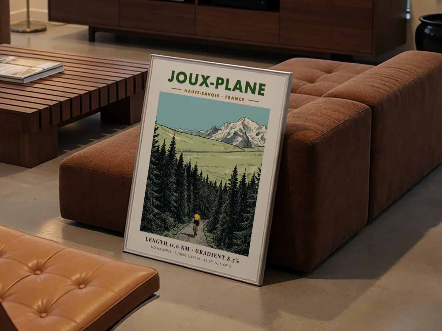 Poster of a cyclist climbing the winding road toward the snowy Joux-Plane mountain.