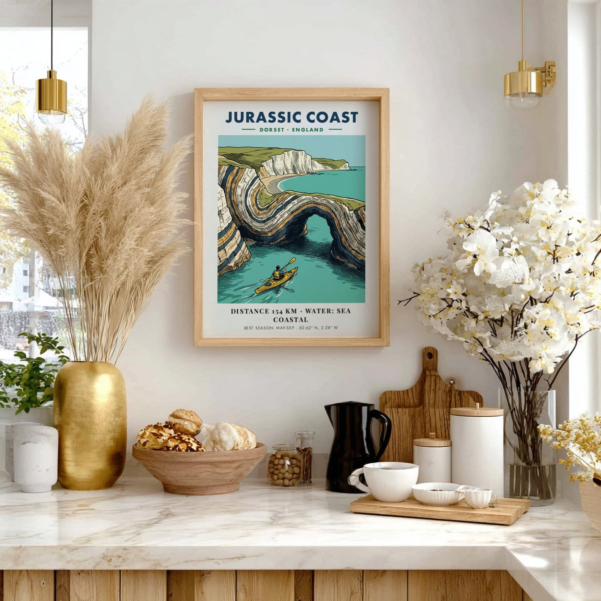 Poster featuring a kayaker paddling through the dramatic limestone arches of the Jurassic Coast.