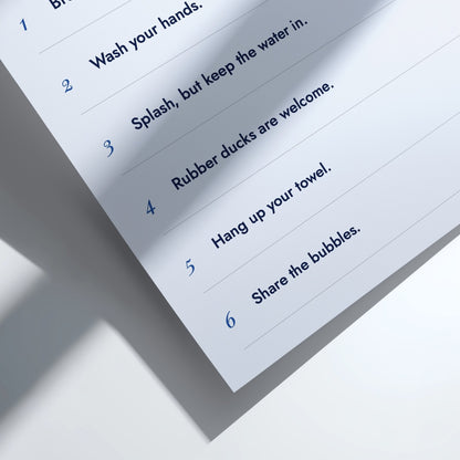 A close-up of a printed instruction sheet showing numbered steps in blue text on a white background, photographed with a soft shadow.