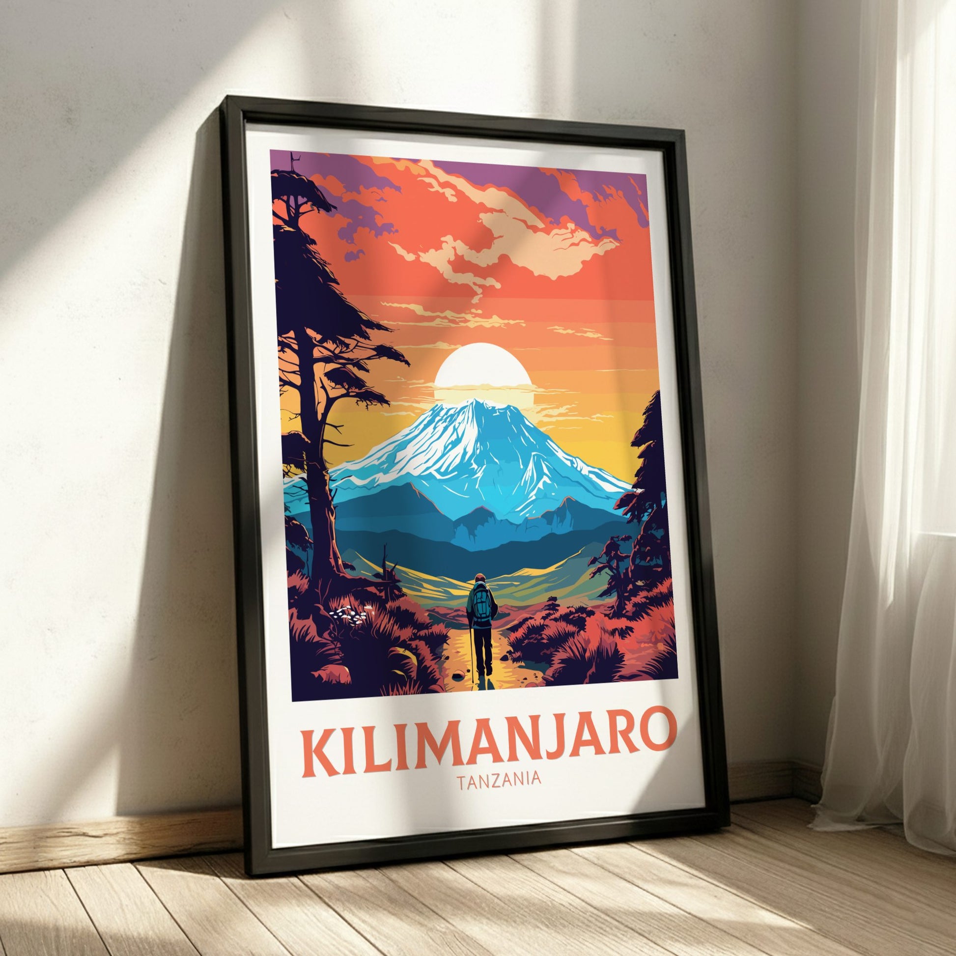 Framed poster of Mount Kilimanjaro with a person looking at the mountain, set against a colorful sky.