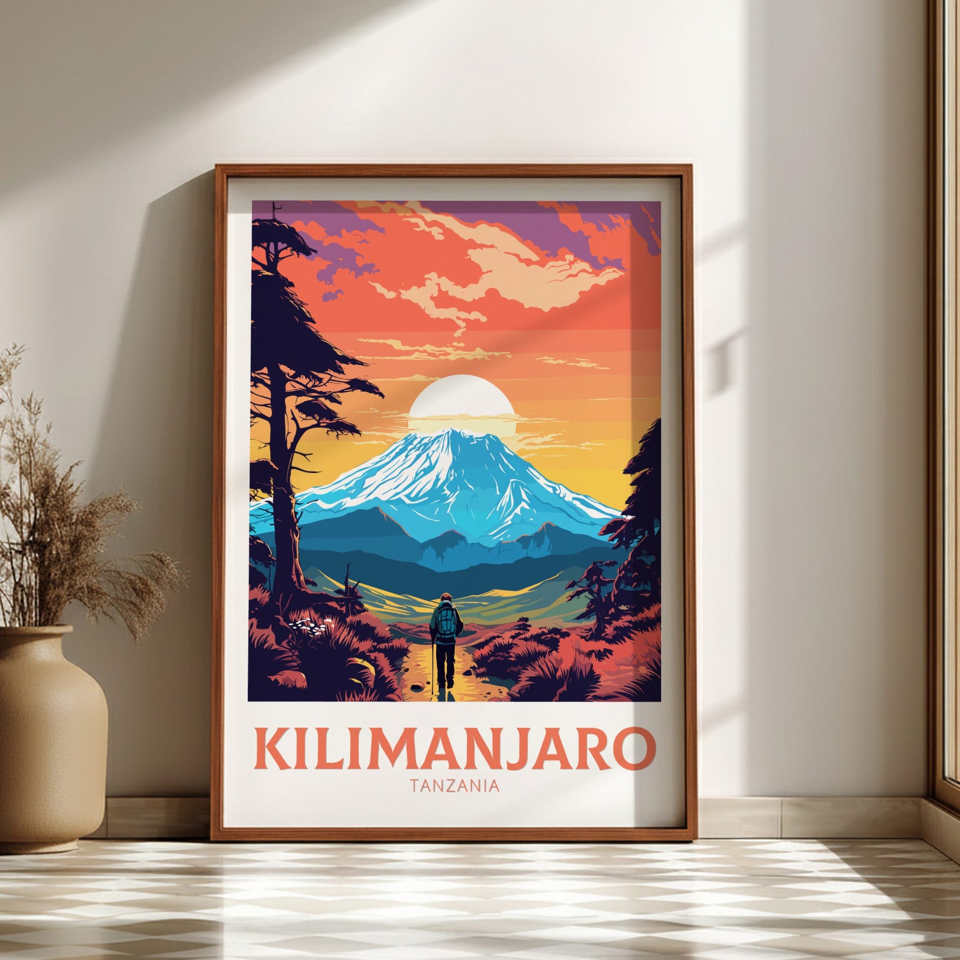 Framed poster of Mount Kilimanjaro with a person looking at the mountain, placed on a wall.