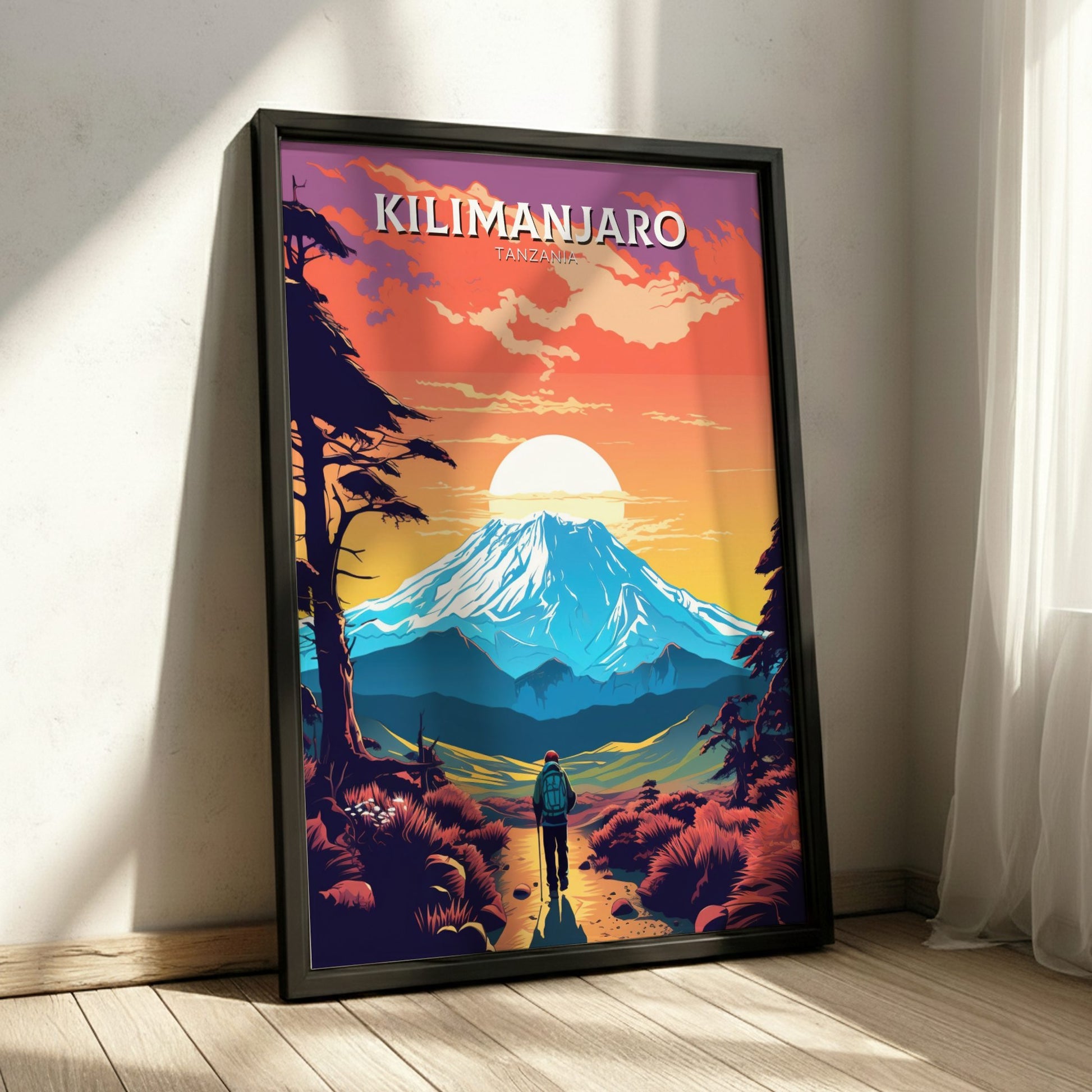 Framed poster of Mount Kilimanjaro with a person looking towards it, set against a colorful sky.
