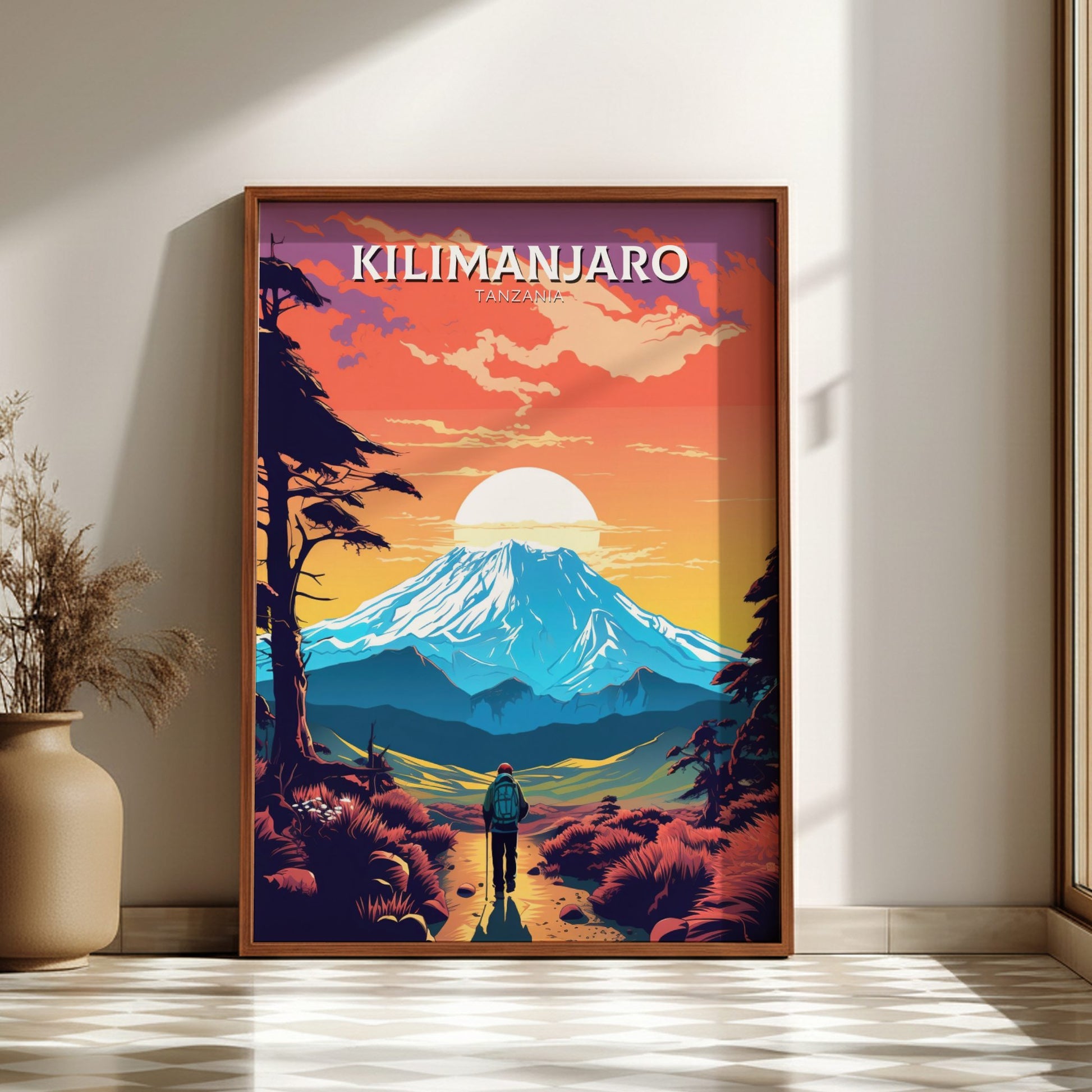 Framed poster of Mount Kilimanjaro with a person standing in front, on a wall in a room.