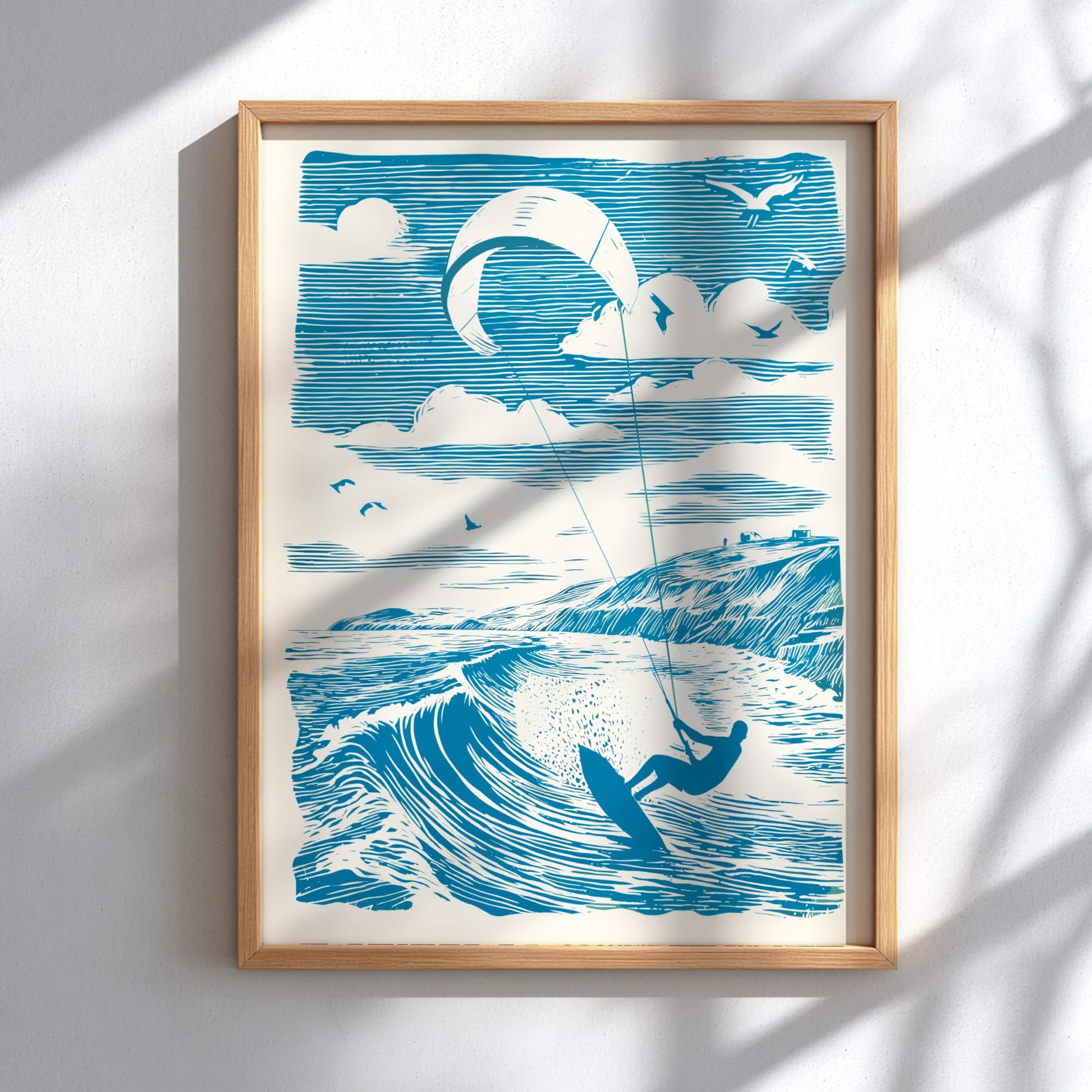 Framed artwork of a kite surfer on a wave with a blue sky and clouds.