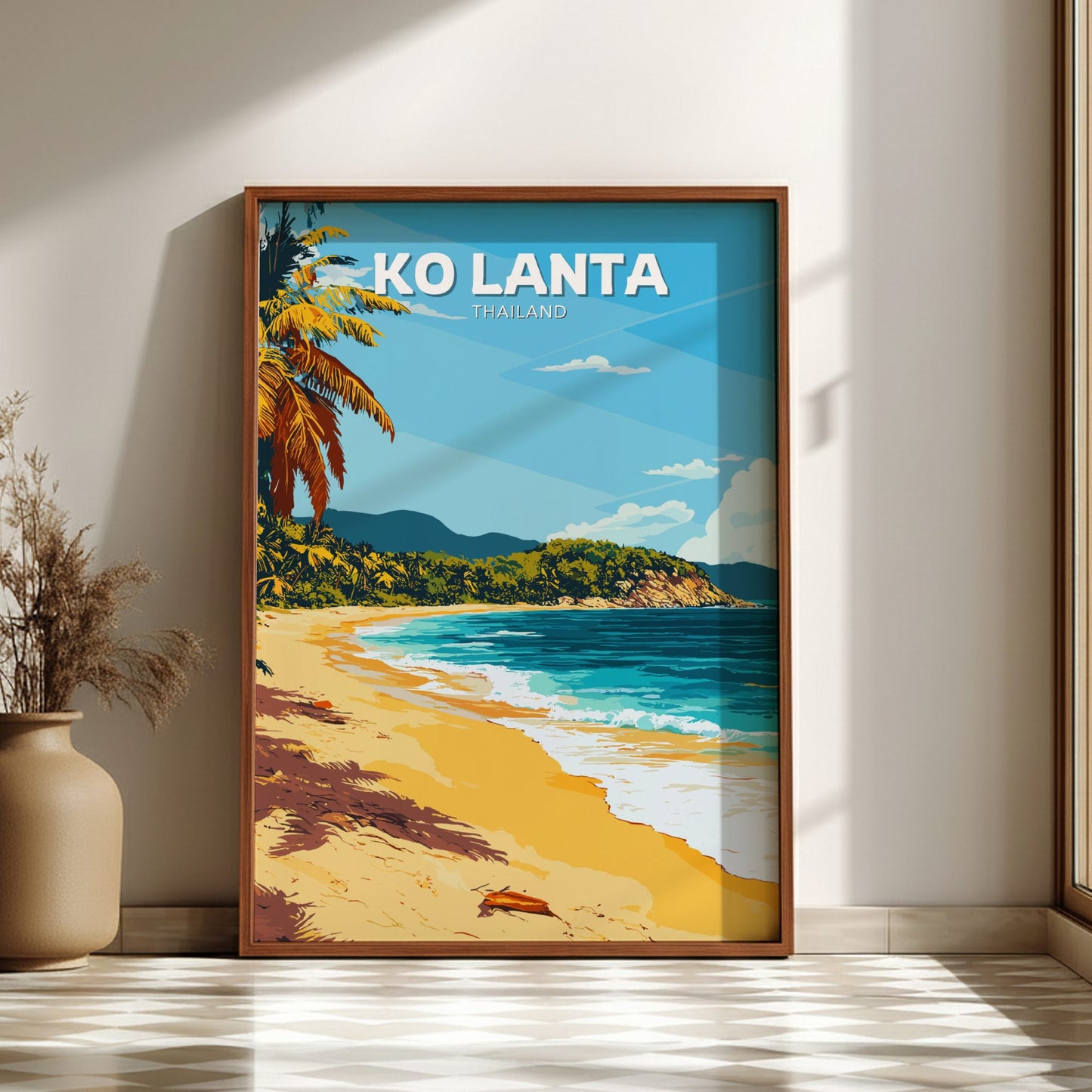 Framed artwork of a tropical beach scene with 'Ko Lanta, Thailand' text on a wall.