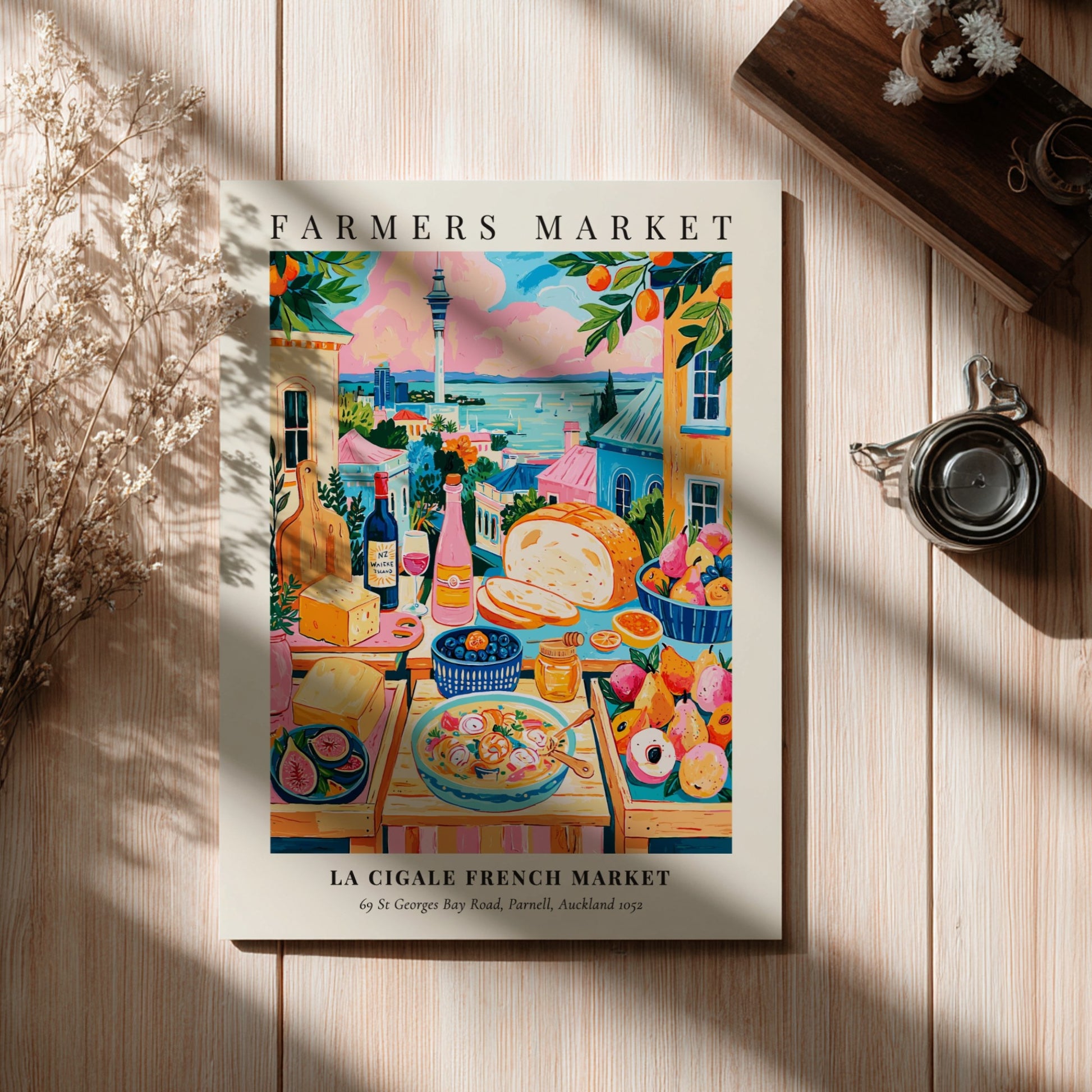 Farmers market poster featuring colorful produce and scenic view of La Cigale French Market in Auckland