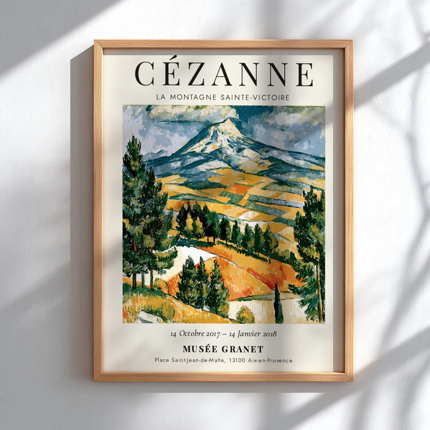 Cézanne exhibition poster featuring La Montagne Sainte-Victoire with vibrant colors and expressive