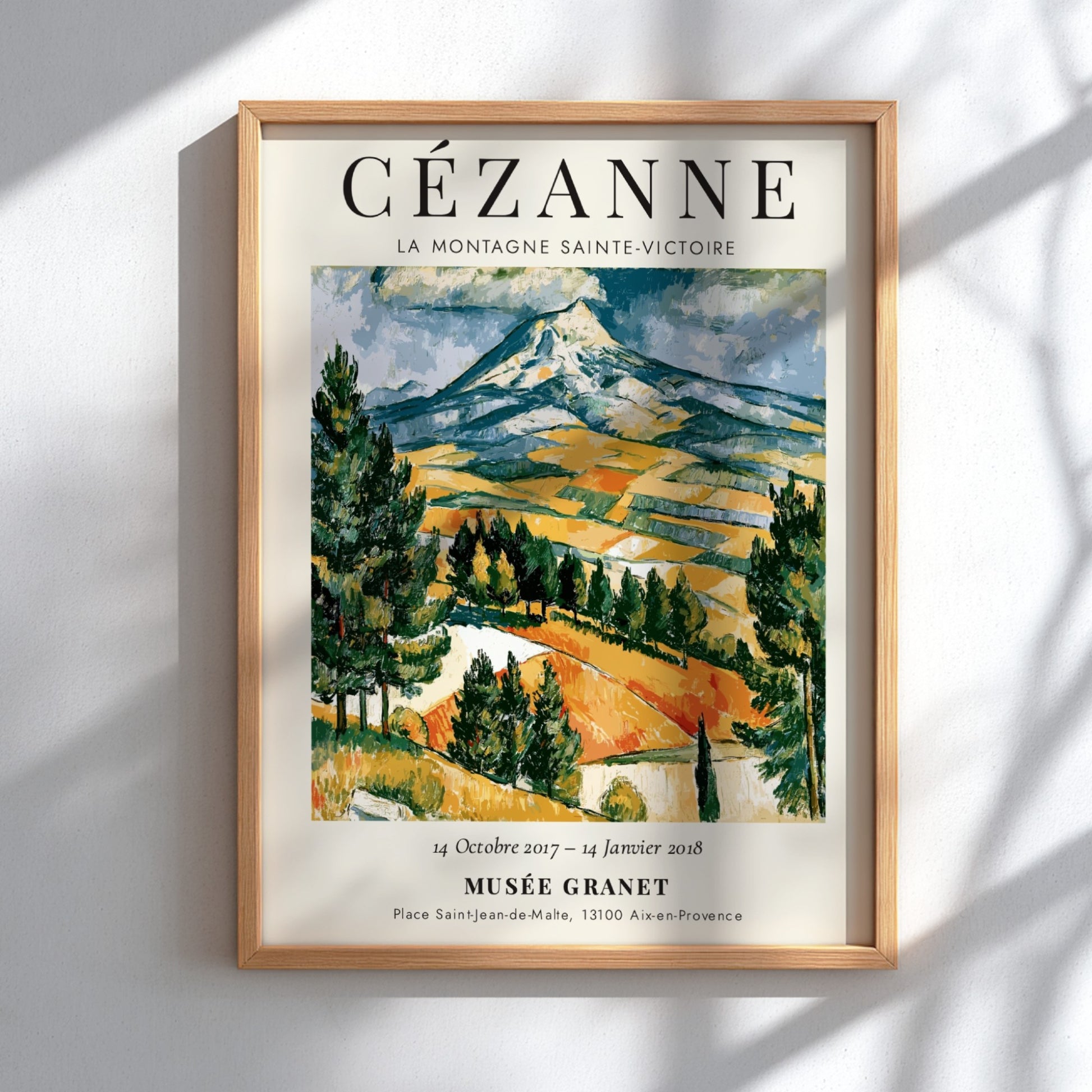 Cézanne exhibition poster featuring La Montagne Sainte-Victoire with vibrant colors and expressive