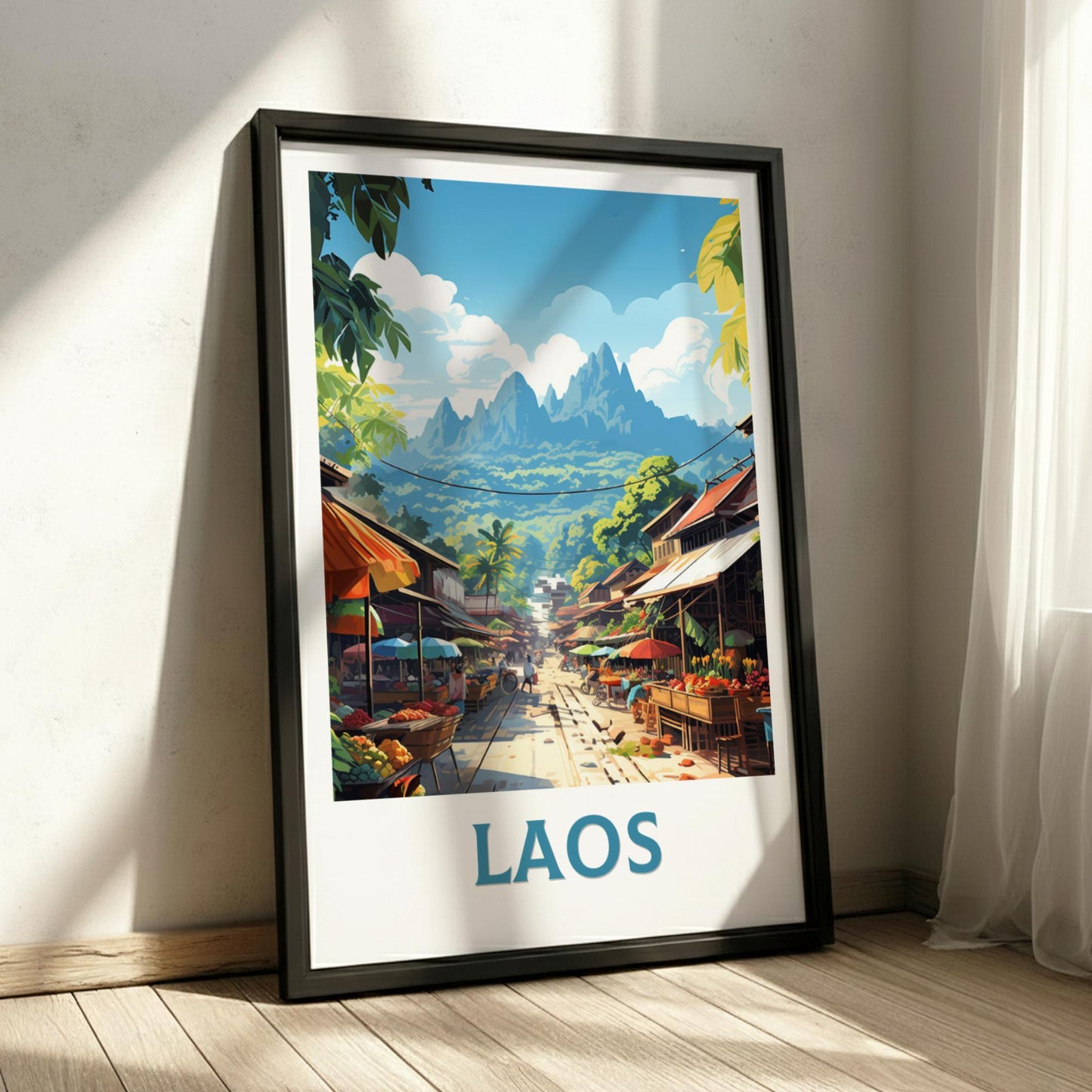 Framed artwork of a street scene in Laos with mountains in the background.