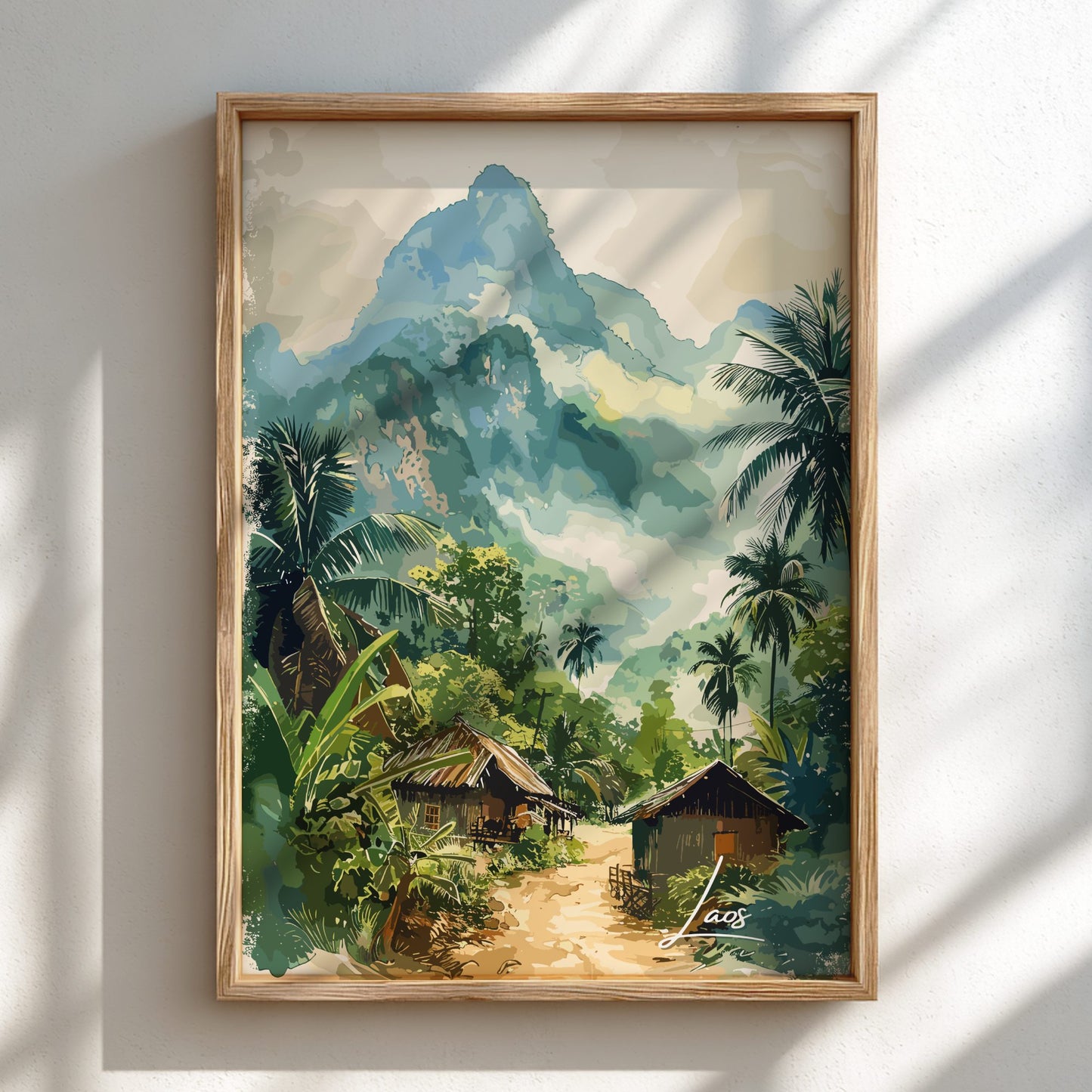 Framed artwork of a tropical landscape with huts and mountains.