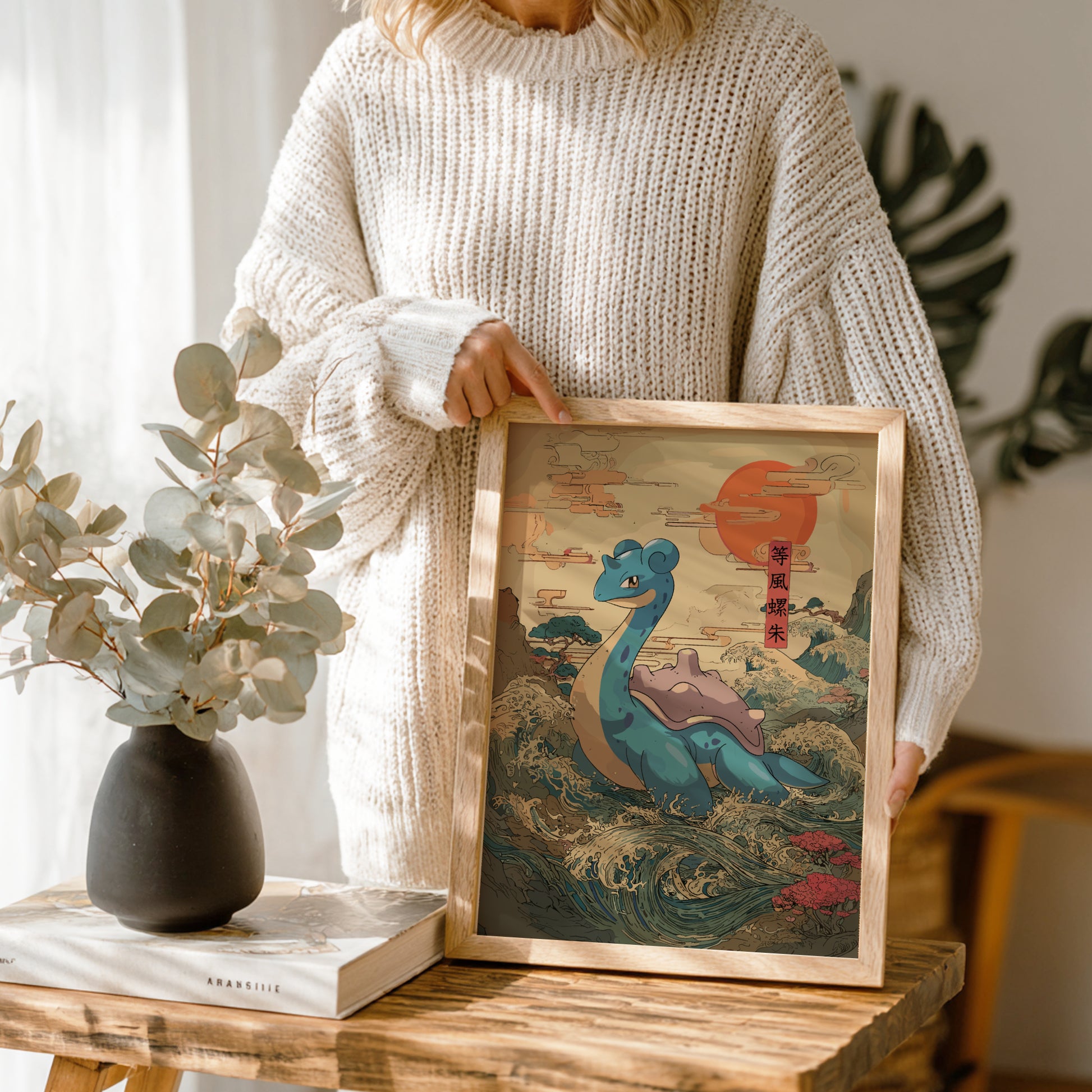 Person holding a framed artwork of Lapras Pokemon in a natural setting