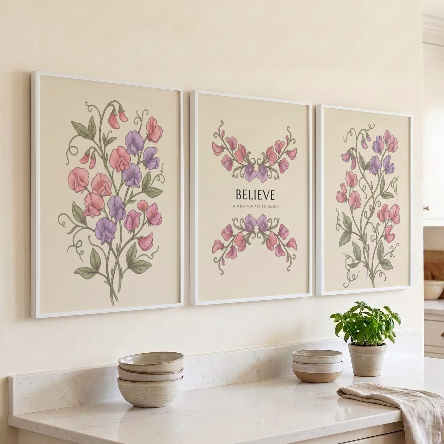 Poster triptych featuring sweet pea flowers and the word believe on a cream background.