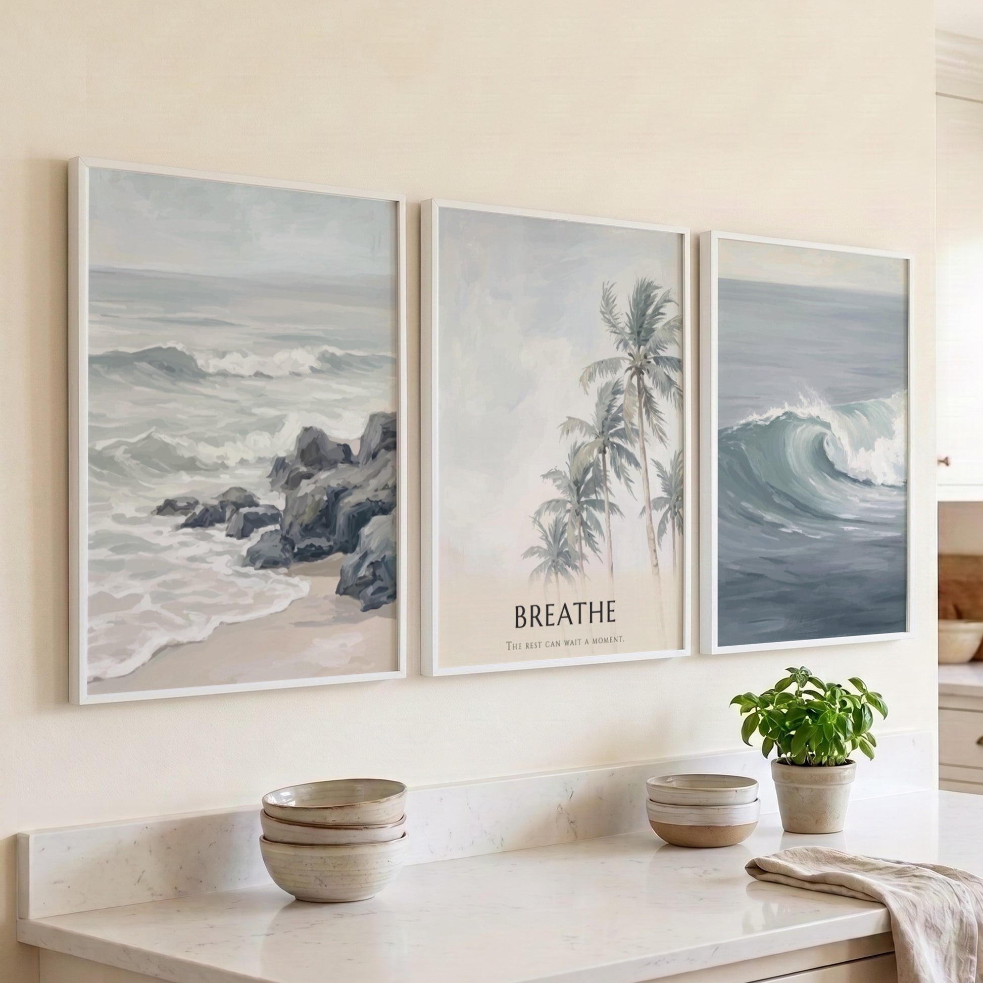Poster triptych of ocean waves and palm trees with Breathe text on wall
