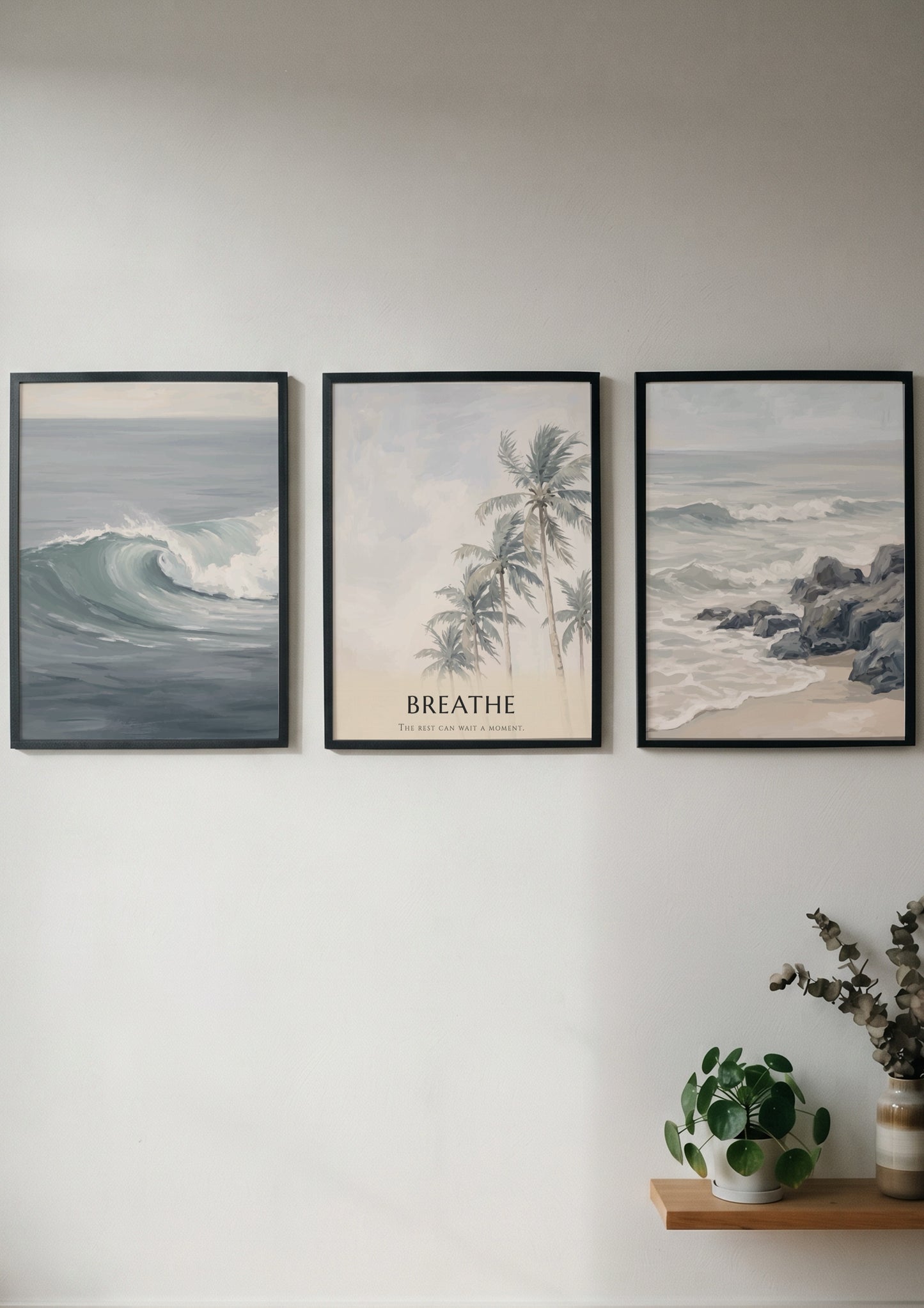 Poster triptych of ocean waves and palm trees with Breathe text on wall