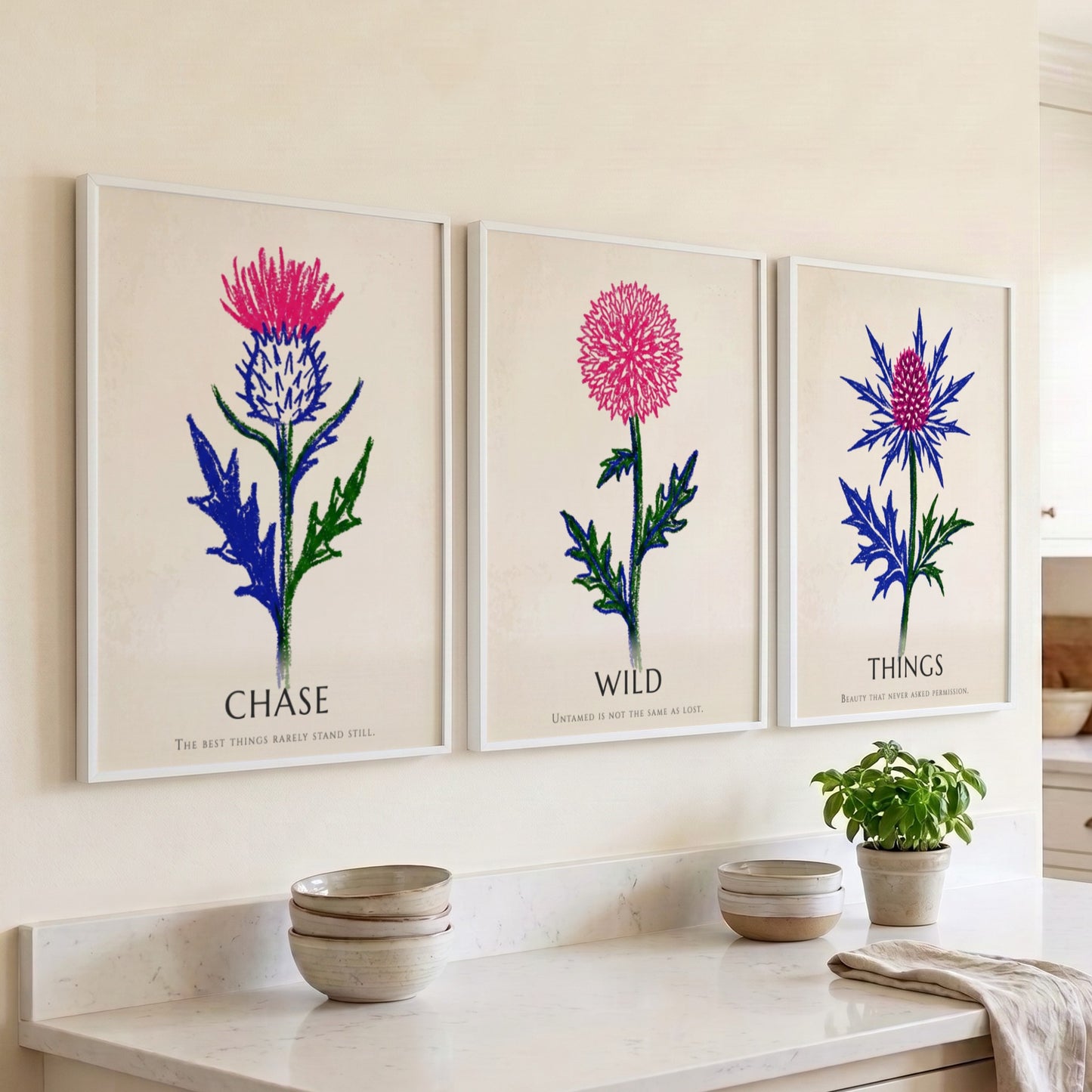 Poster set featuring Things Wild Chase text with vibrant pink and blue thistles