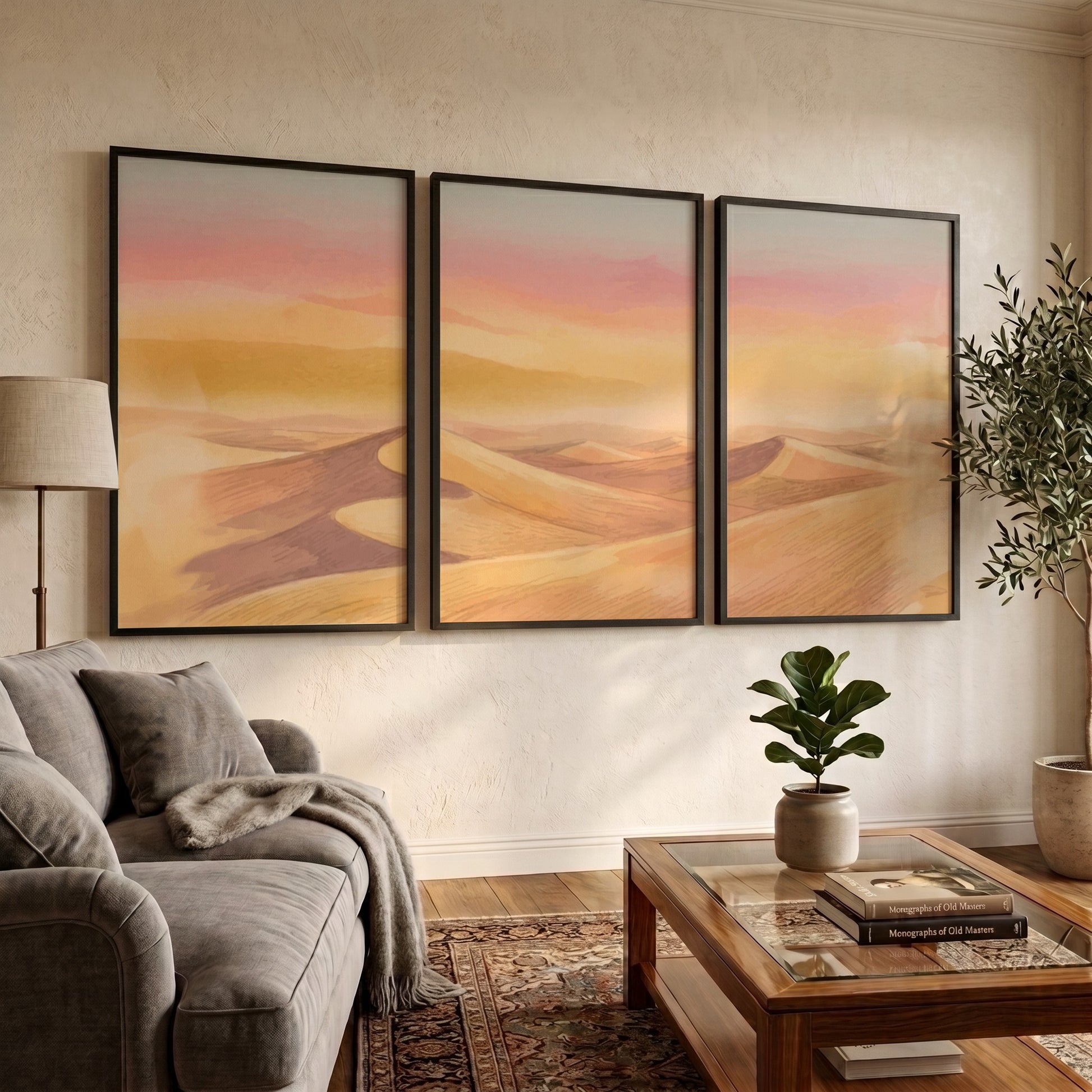 Three framed landscape prints showing golden desert dunes under a soft sunset sky