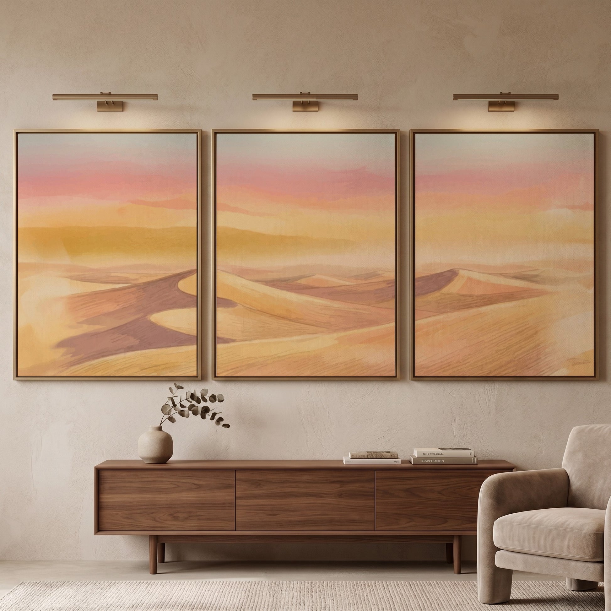 Three framed landscape prints showing golden desert dunes under a soft sunset sky