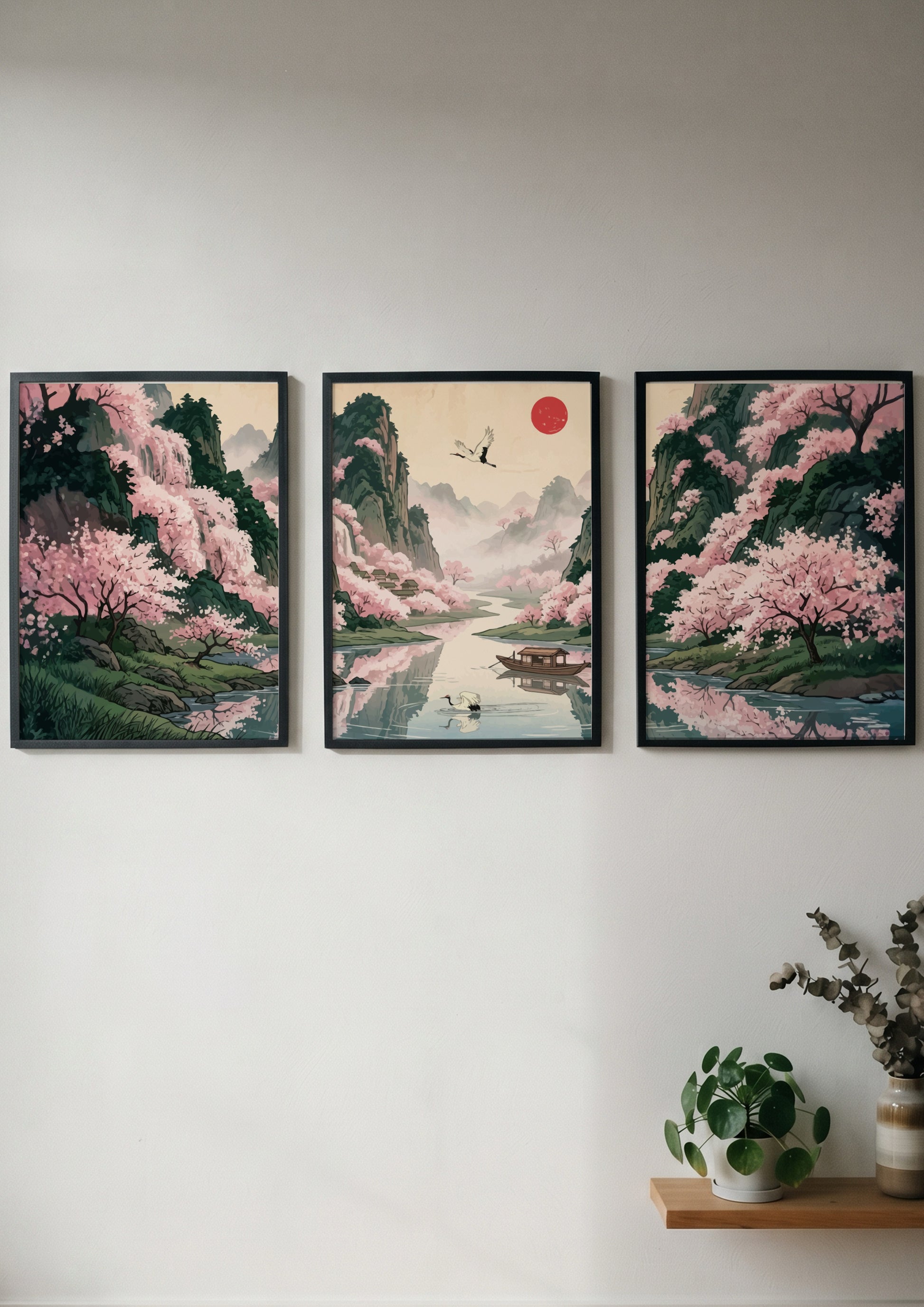Three framed Japanese landscape panels featuring pink cherry blossoms, a river, and mountains.