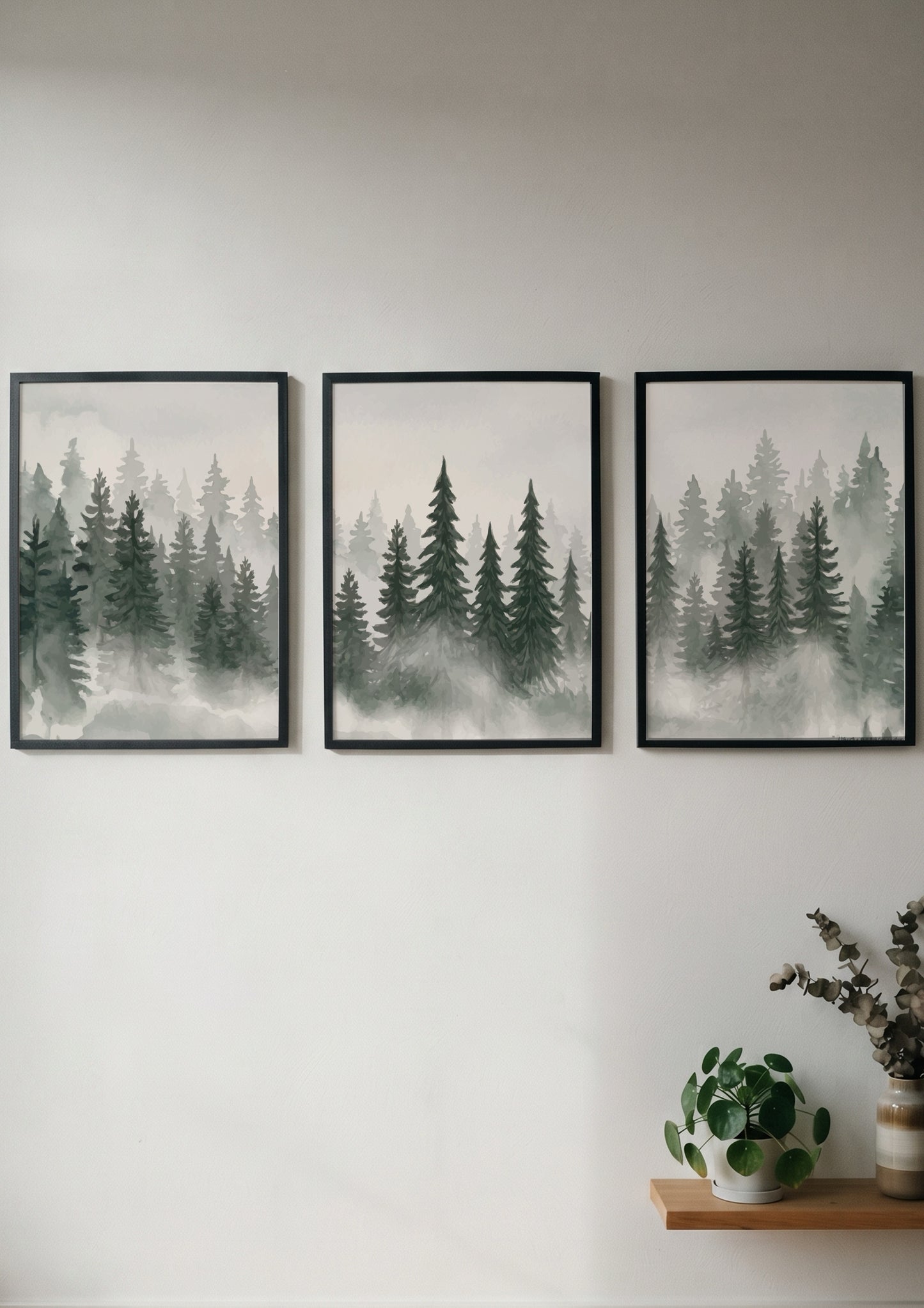 Three framed prints showing a misty pine forest in shades of green and grey