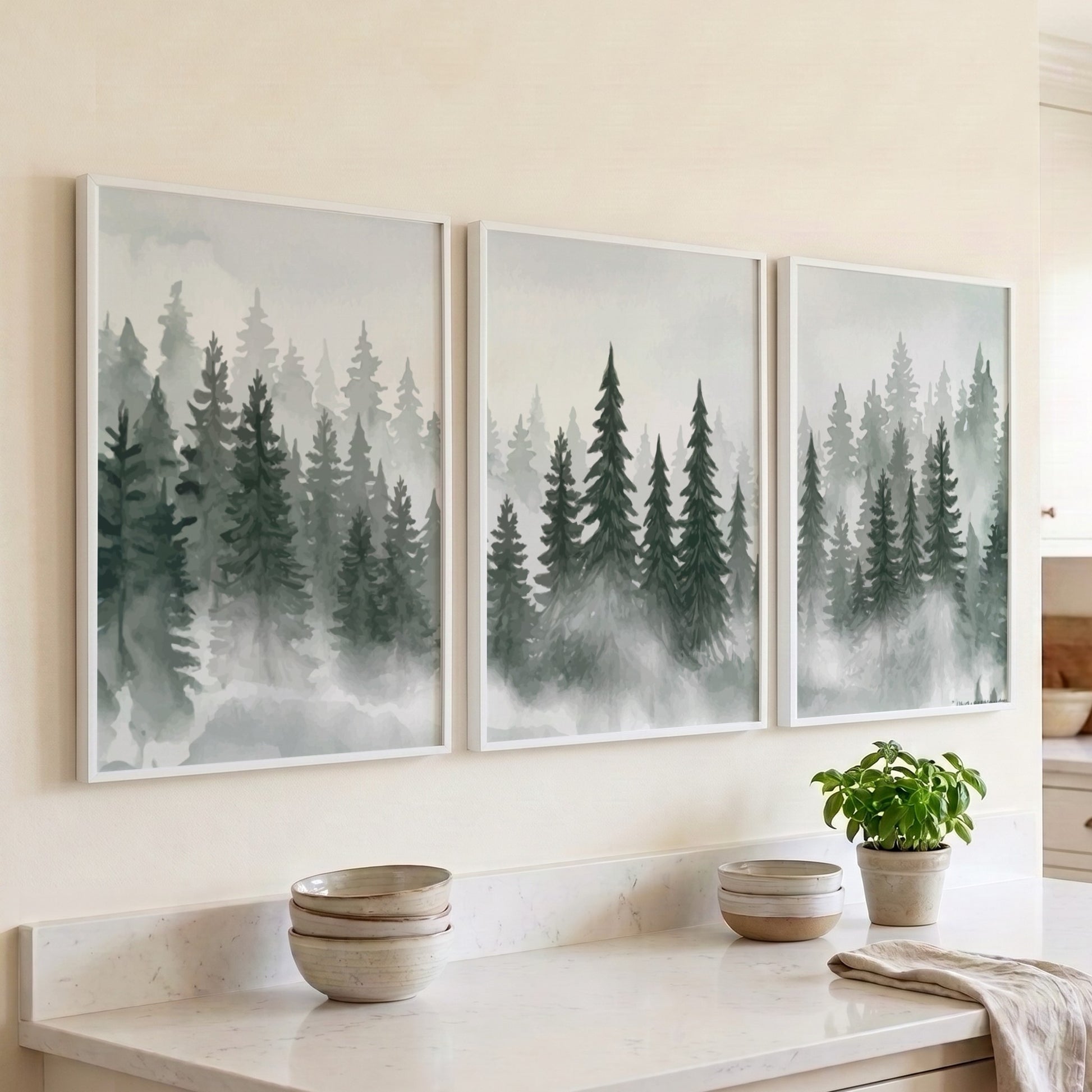 Three framed prints showing a misty pine forest in shades of green and grey