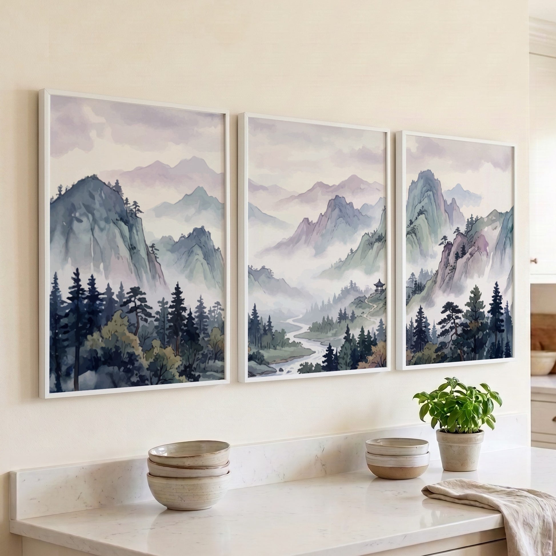Triptych of Japanese mountain valley landscape prints in soft watercolour blues and lavenders.