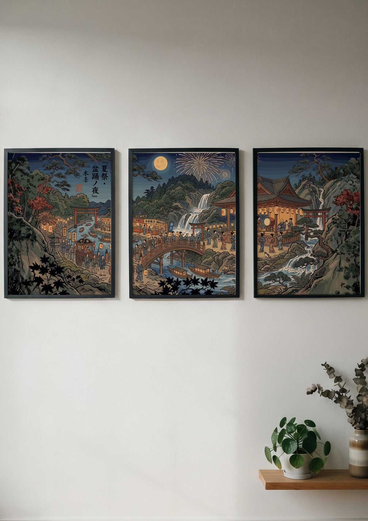 Three framed Japanese Ukiyo-e style posters showing a night festival with lanterns and waterfalls