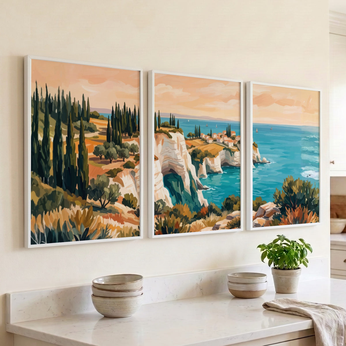 Three framed landscape prints showing Mediterranean cliffs cypress trees and blue ocean water