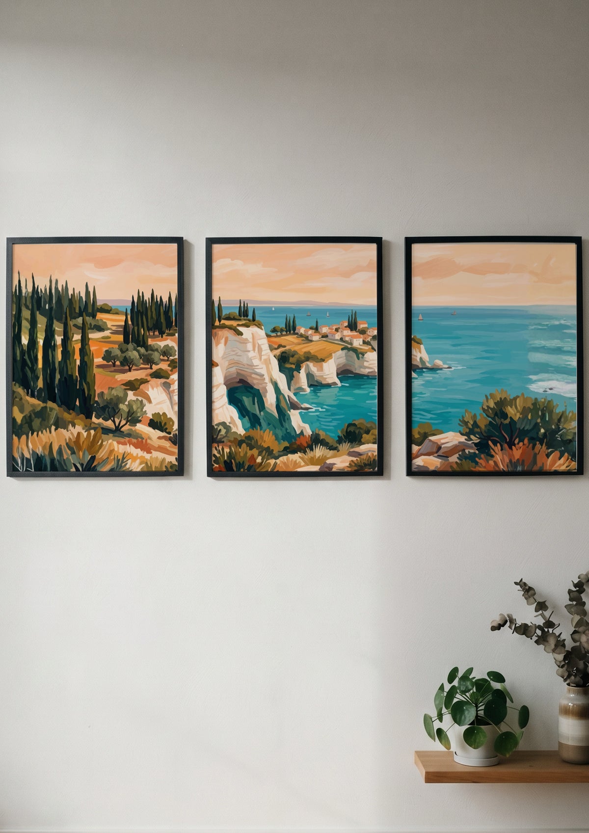 Three framed landscape prints showing Mediterranean cliffs cypress trees and blue ocean water