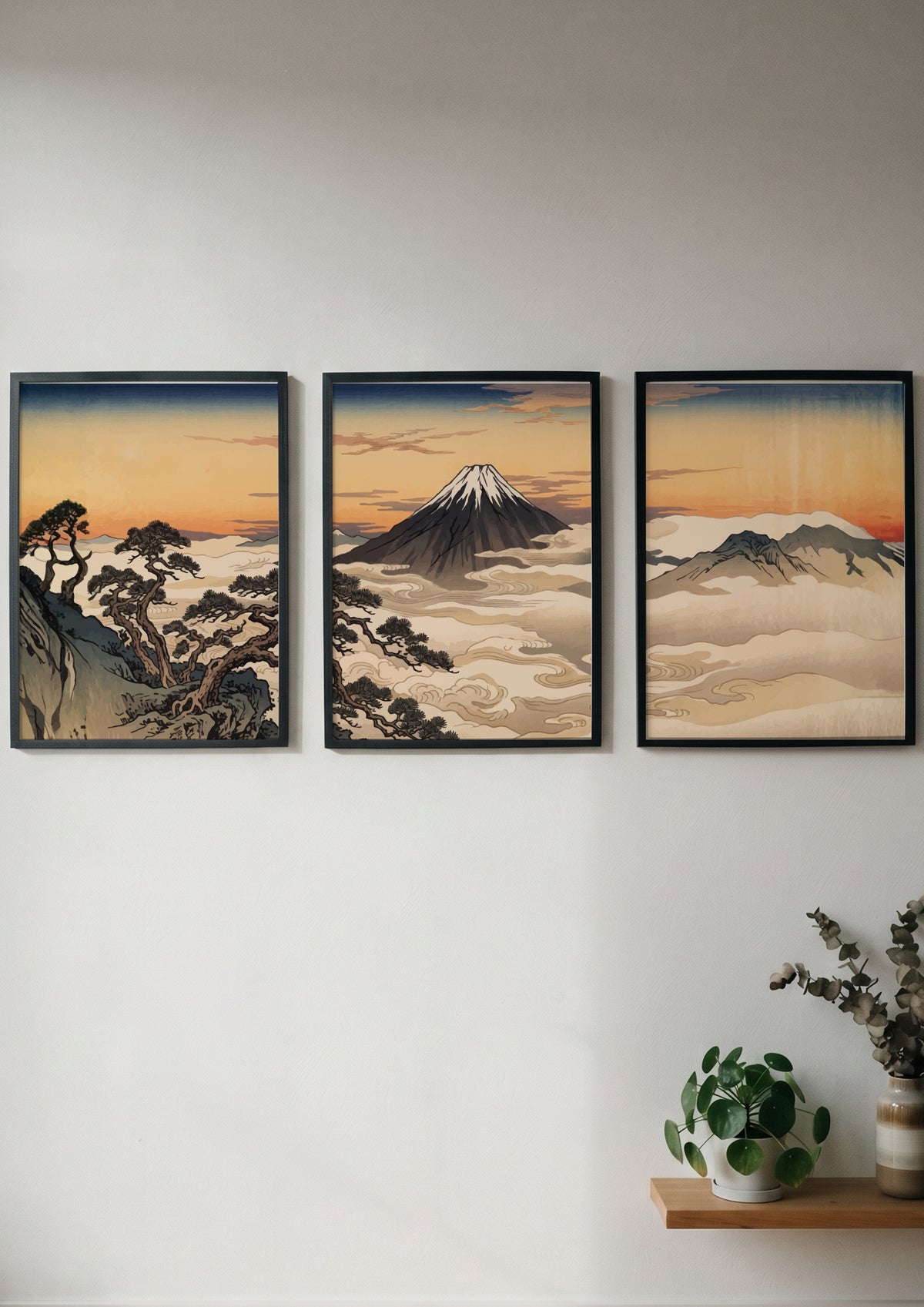 Three framed Japanese landscape prints featuring Mount Fuji rising above clouds at sunset
