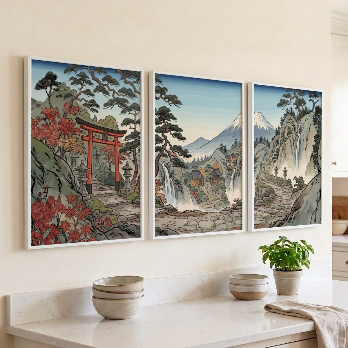 Three framed Japanese woodblock prints displaying a torii gate, waterfalls, and Mount Fuji.