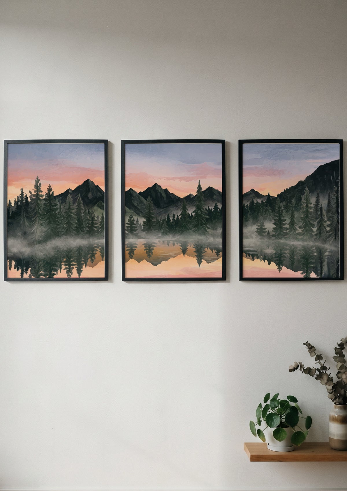Three framed landscape prints showing misty mountains and pine trees reflected in water