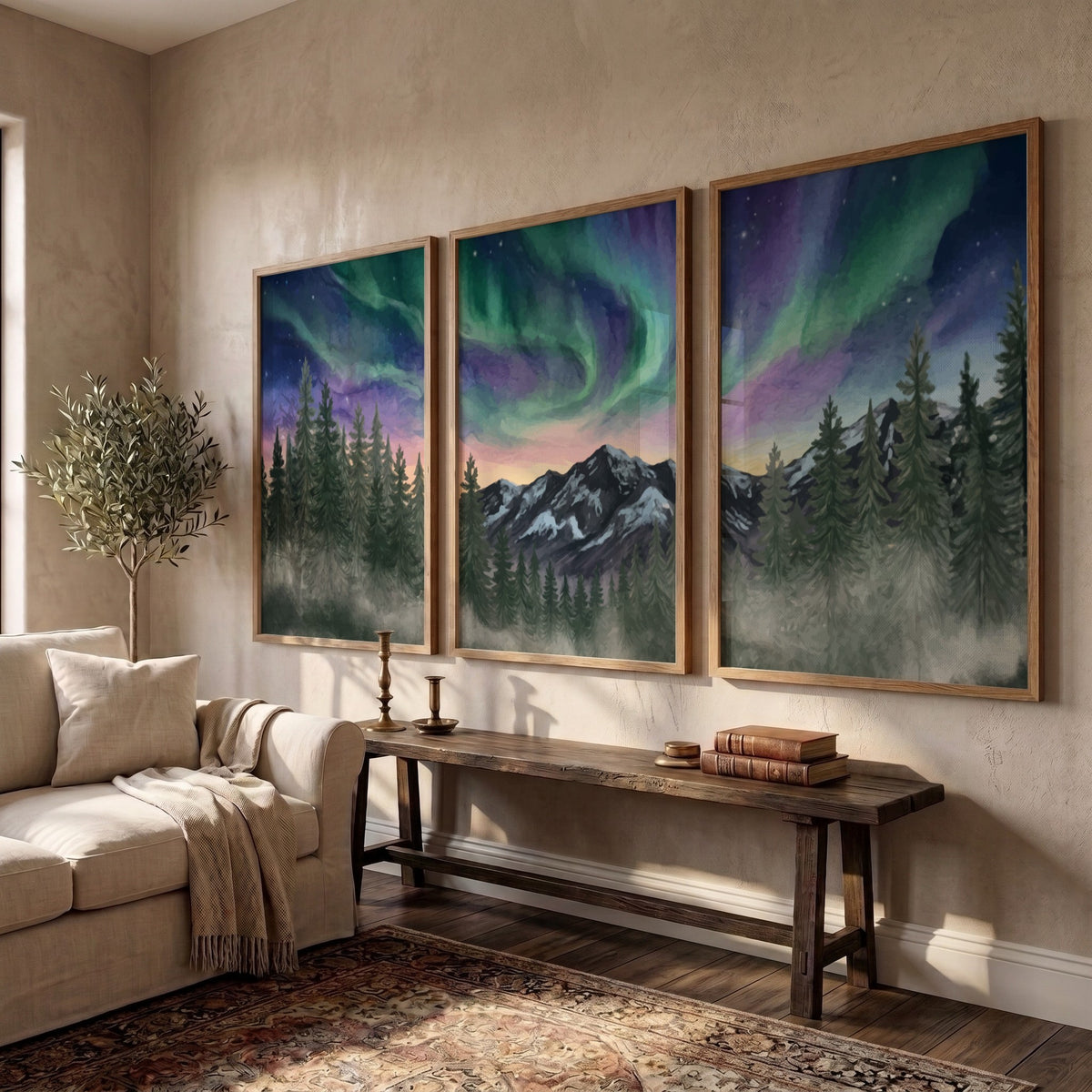Three framed landscape prints showing green and purple aurora borealis over mountain forests
