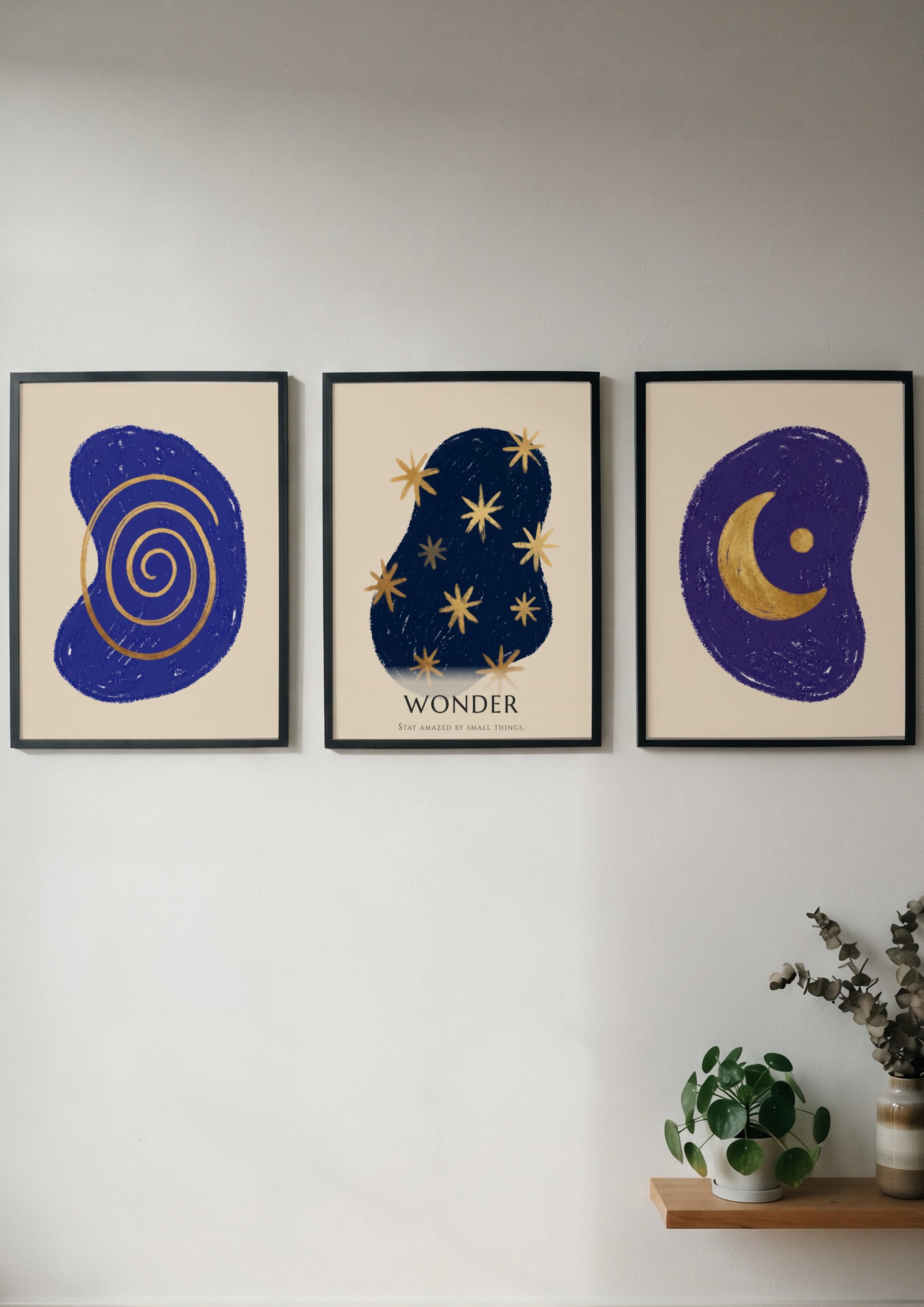 Poster triptych featuring navy blue abstract shapes with golden spiral stars and moon
