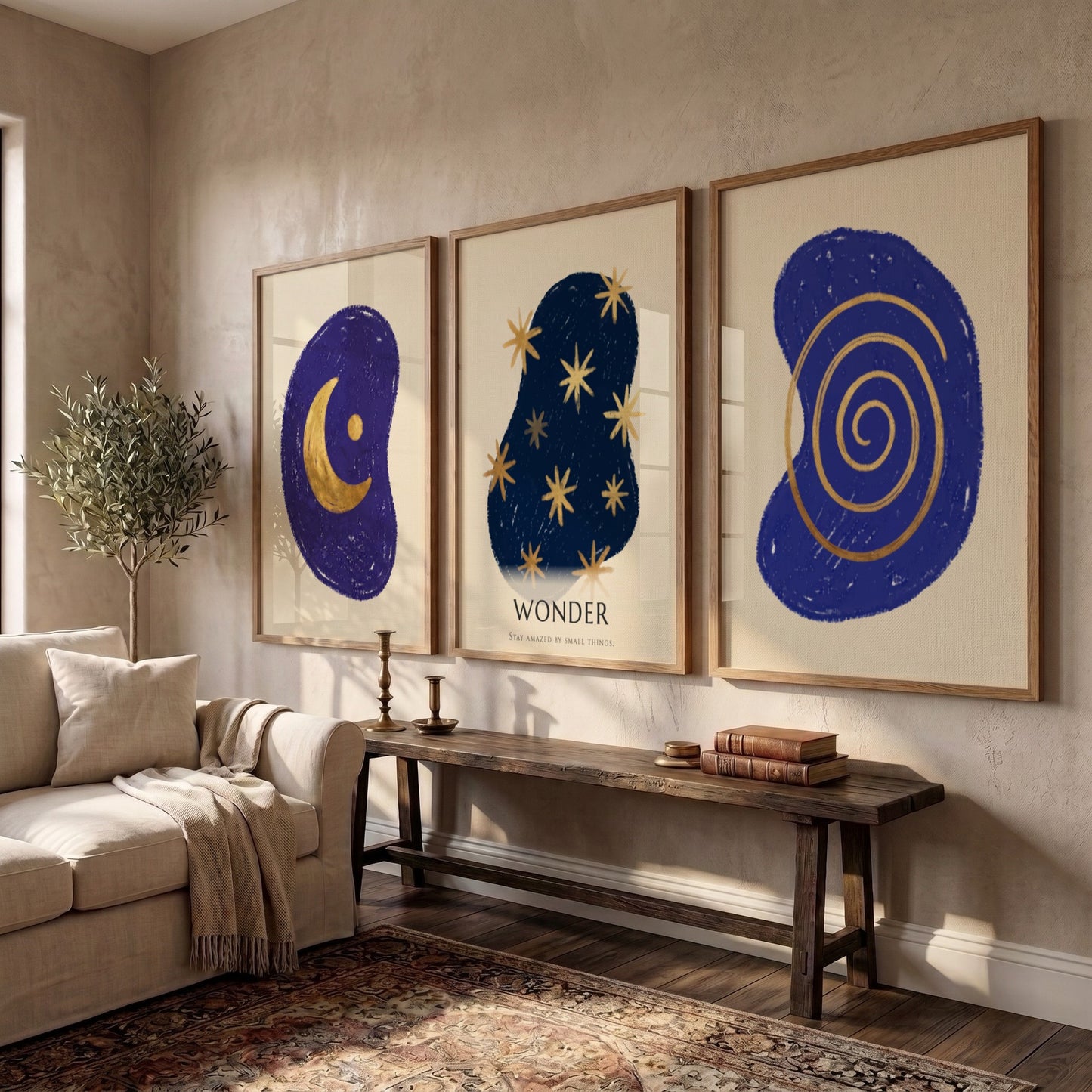Poster triptych featuring navy blue abstract shapes with golden spiral stars and moon
