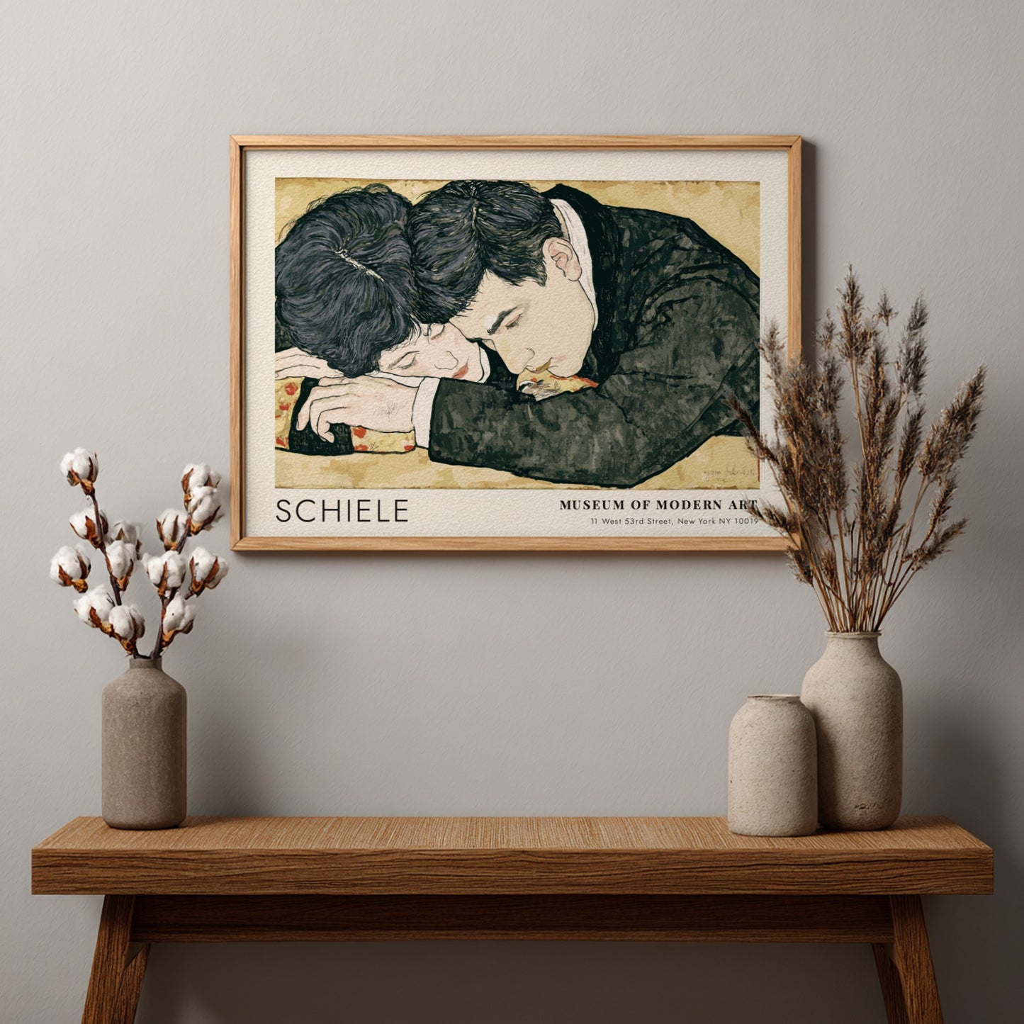 Wall art poster featuring Egon Schiele couple illustration in a wooden frame hanging