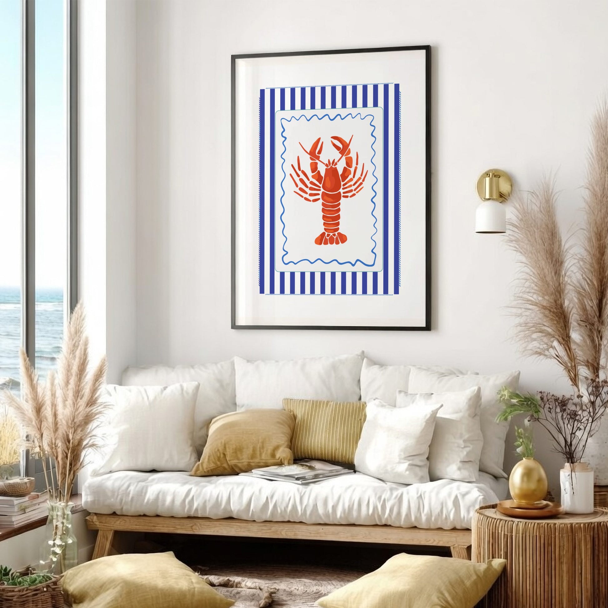 Living room with a white sofa, decorative pillows, and a framed artwork of a red lobster on a blue striped background.
