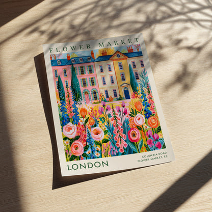 Flower market poster featuring vibrant flowers and city buildings in pink and yellow tones
