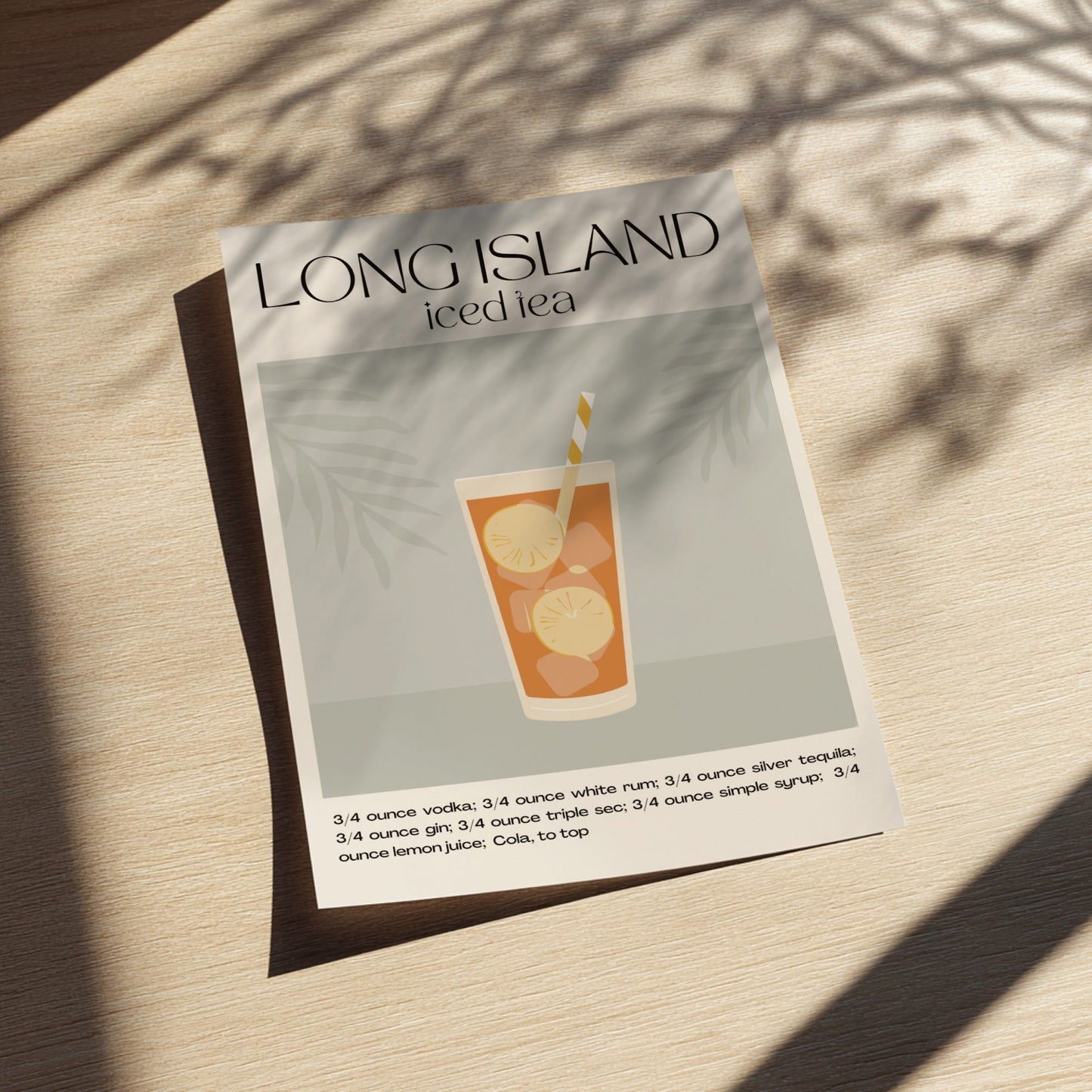 Recipe card for a Long Island iced tea on a light wooden surface with shadows.
