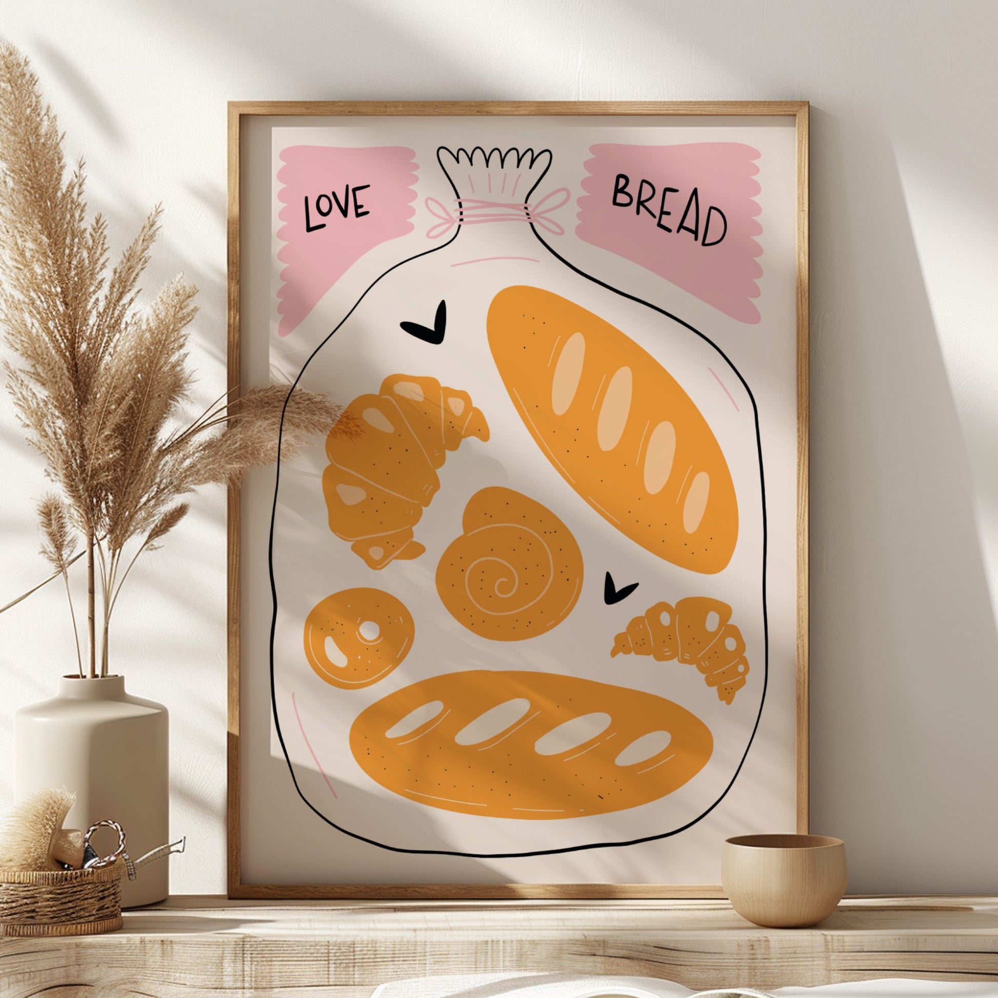 Framed artwork of bread illustrations with 'Love' and 'Bread' text on a wall.