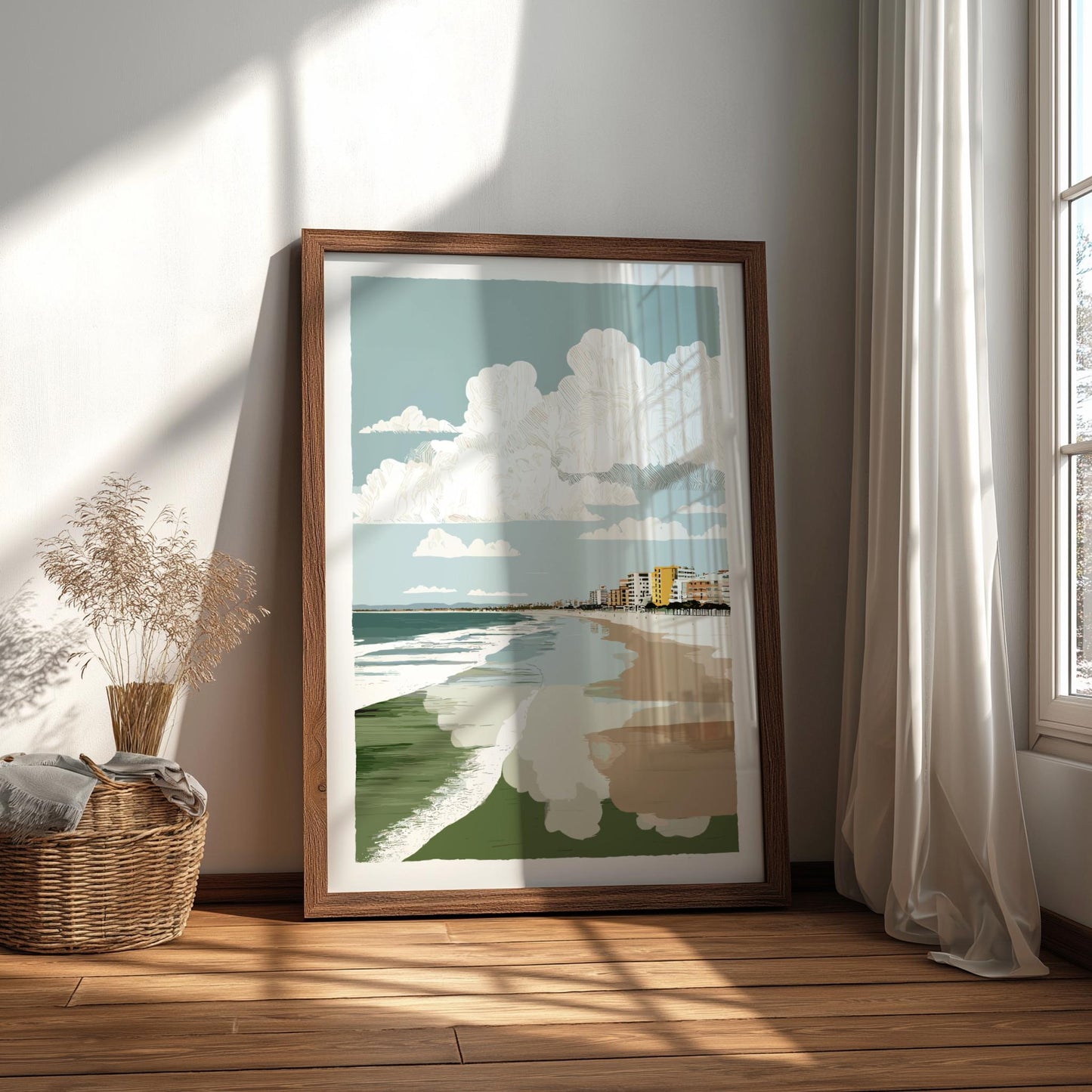 Framed artwork of a beach scene on a wall in a bright room with sunlight streaming through a window.