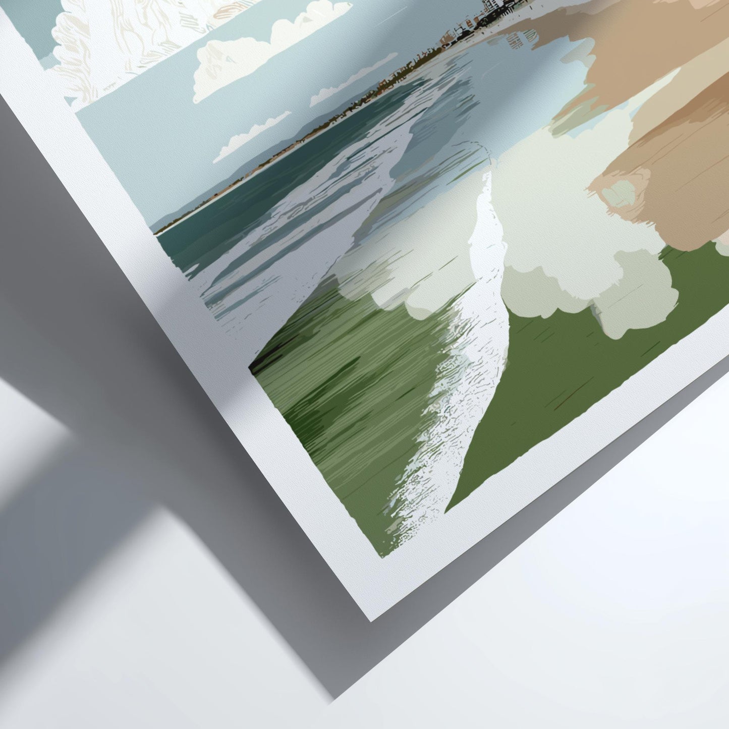 Close-up of a framed landscape print with a hand holding it, on a light gray background.