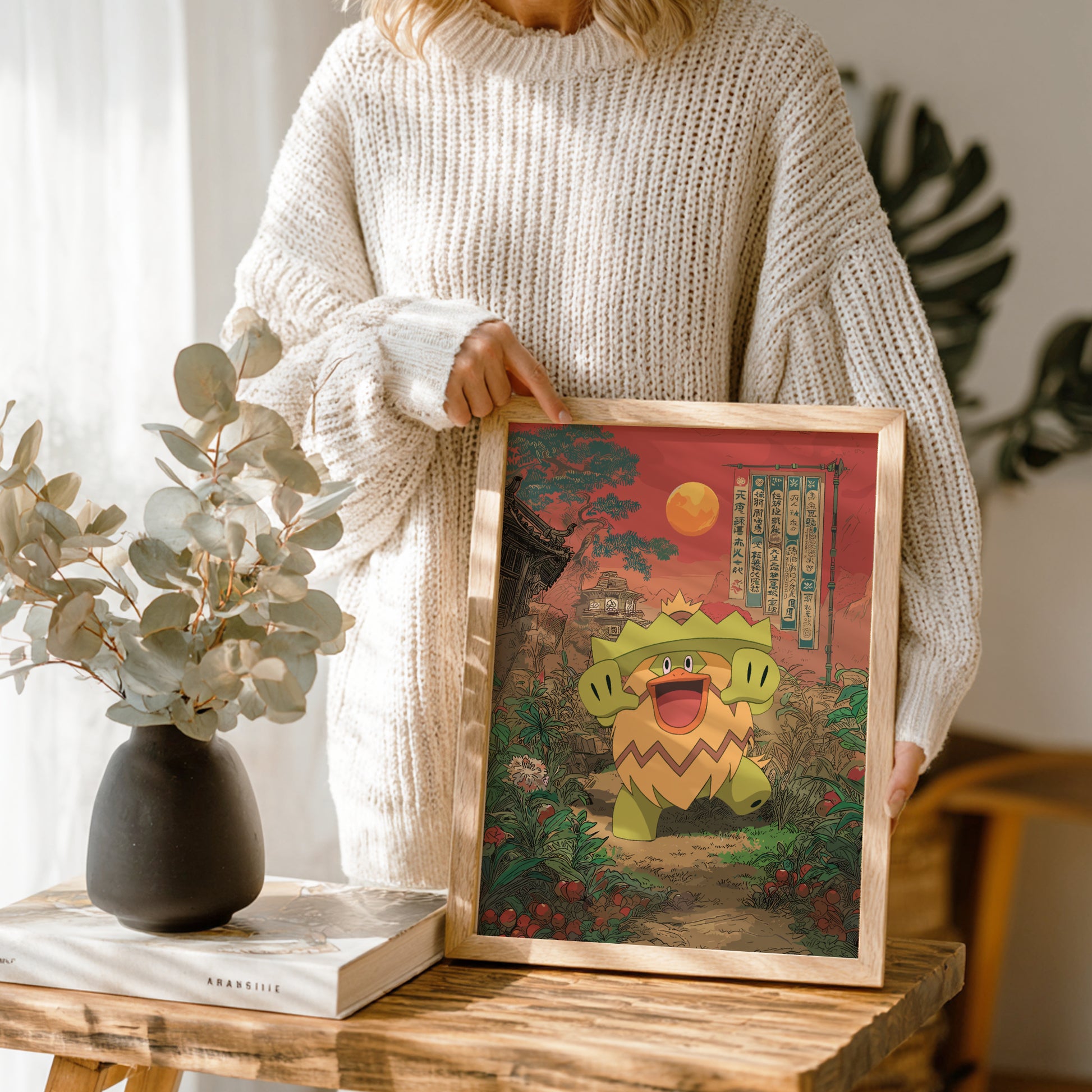 Person holding a framed illustration of Ludicolo Pokemon character in a scenic setting