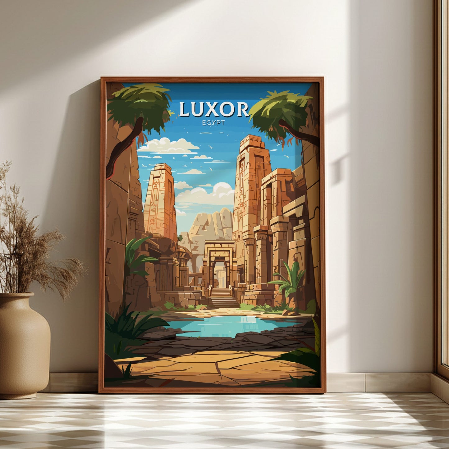 Framed poster of Luxor Temple with palm trees and blue sky, placed on a light wooden floor.