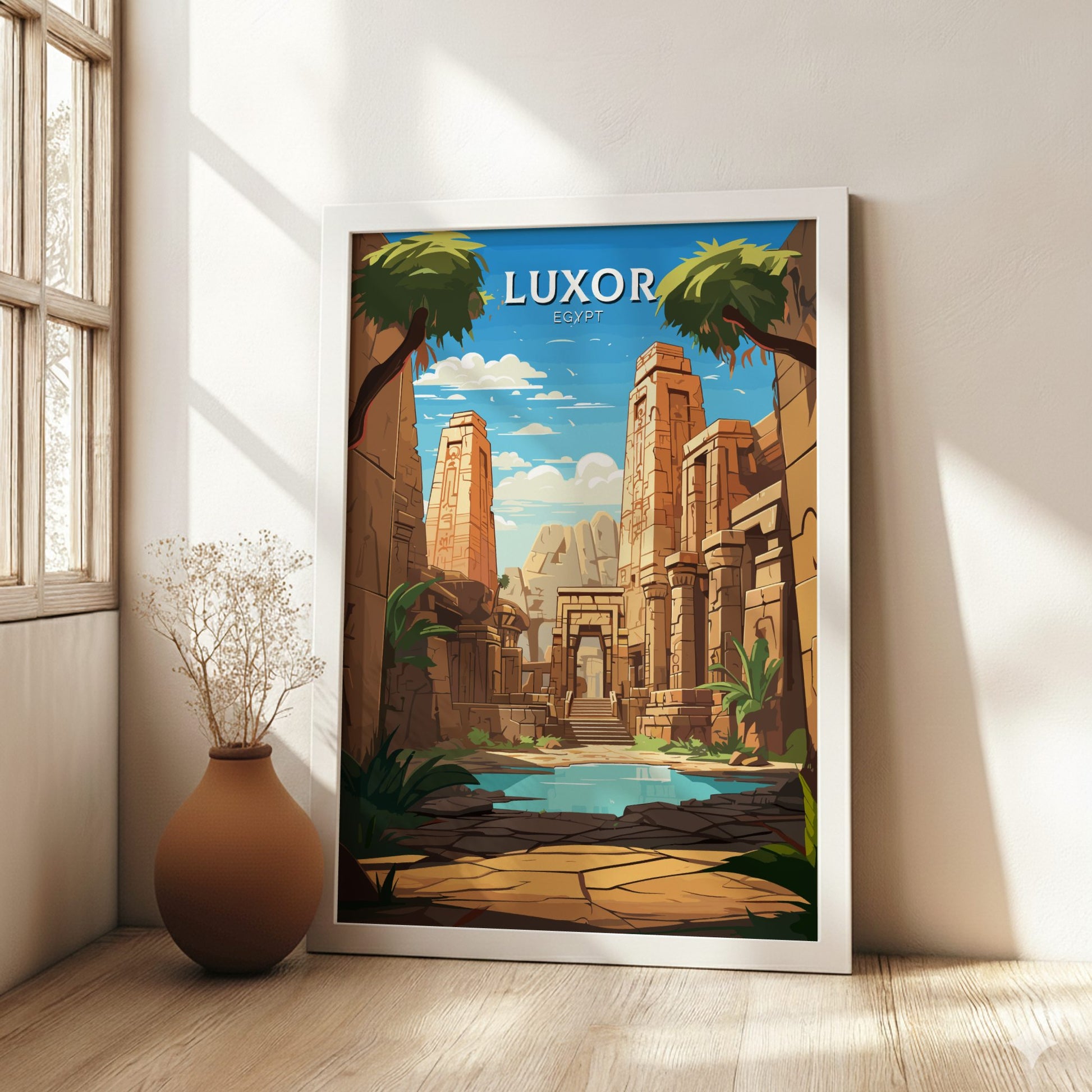 Framed poster of Luxor, Egypt in a room with a vase and window.