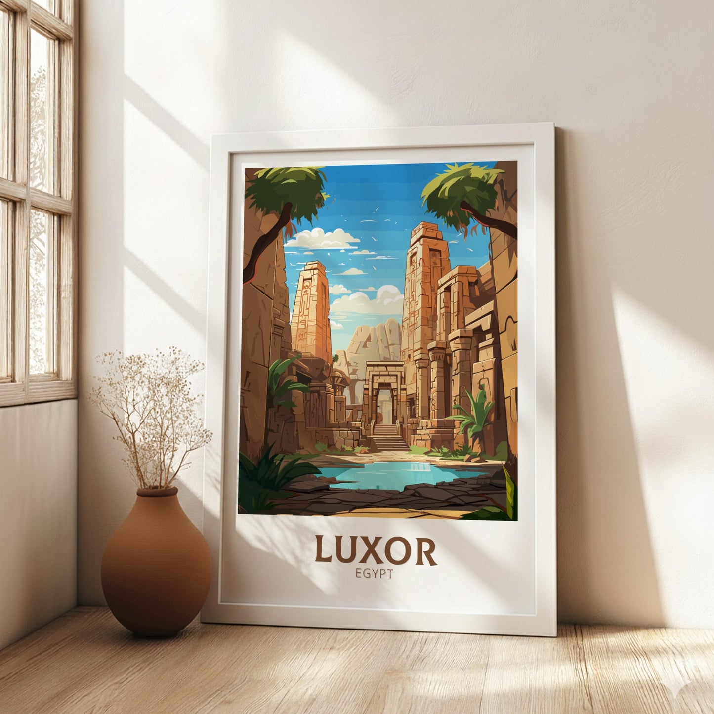 Framed poster of Luxor, Egypt in a room with a vase and window.