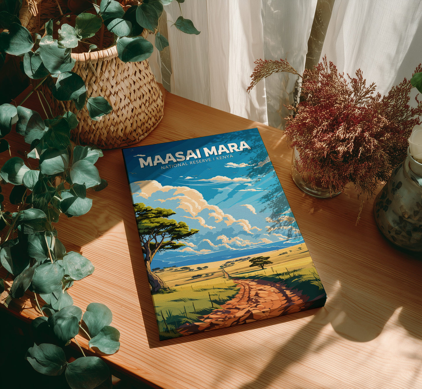 Book titled 'Maasai Mara' on a wooden surface with plants around