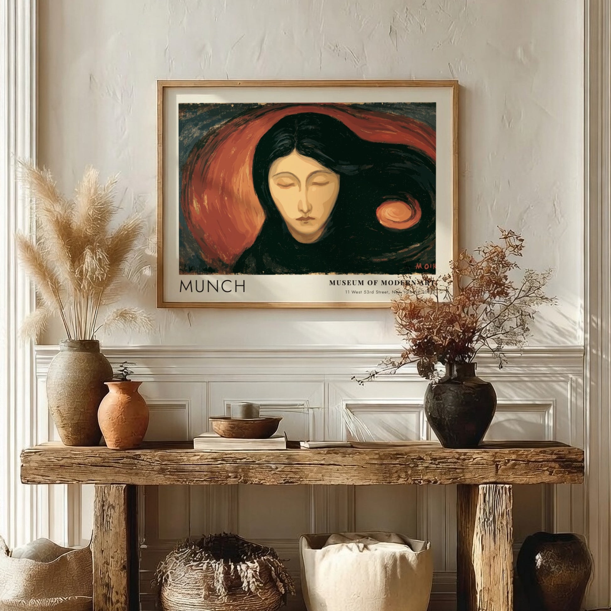 Munch Madonna exhibition poster in a light wood frame on a plain wall