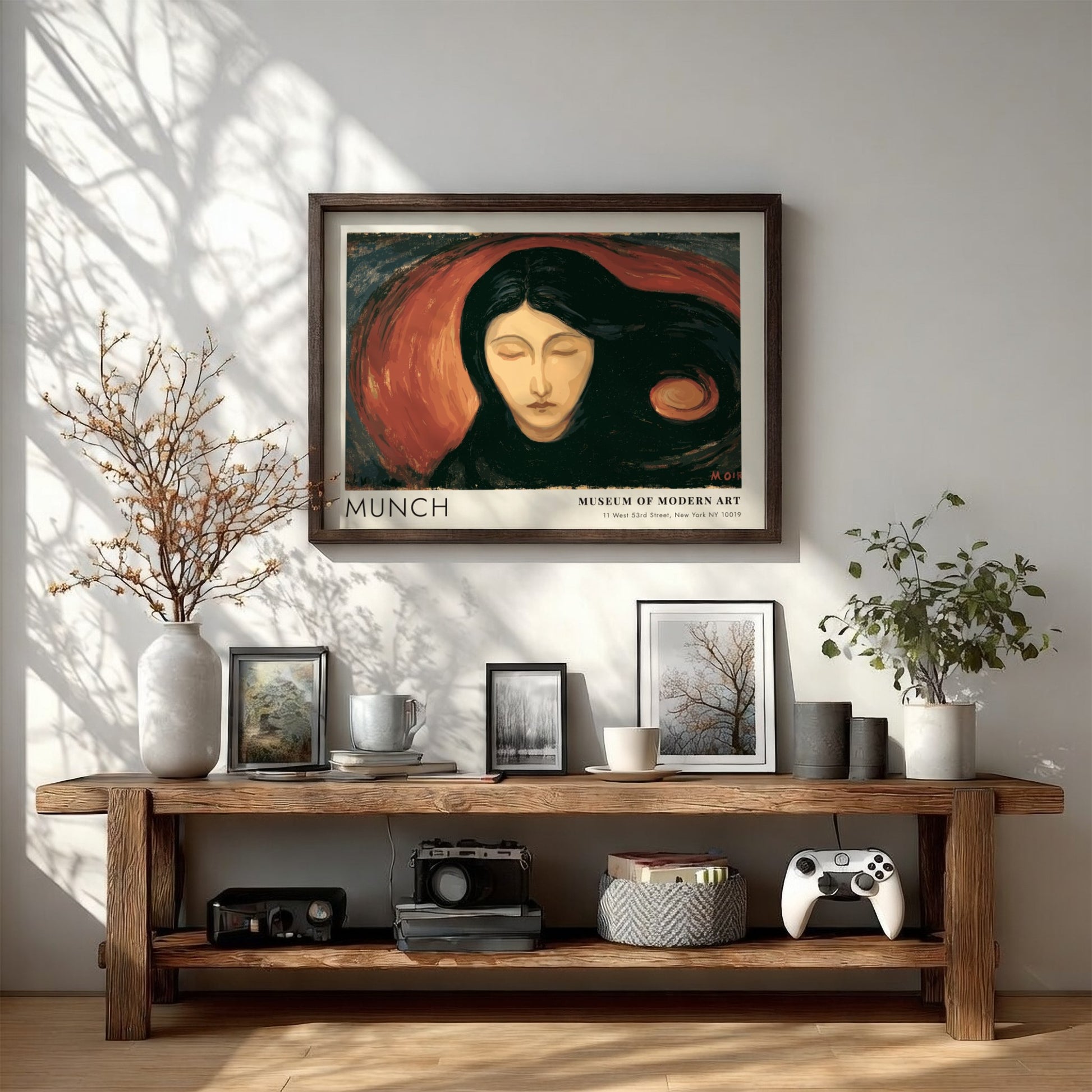 Munch Madonna exhibition poster in a light wood frame on a plain wall